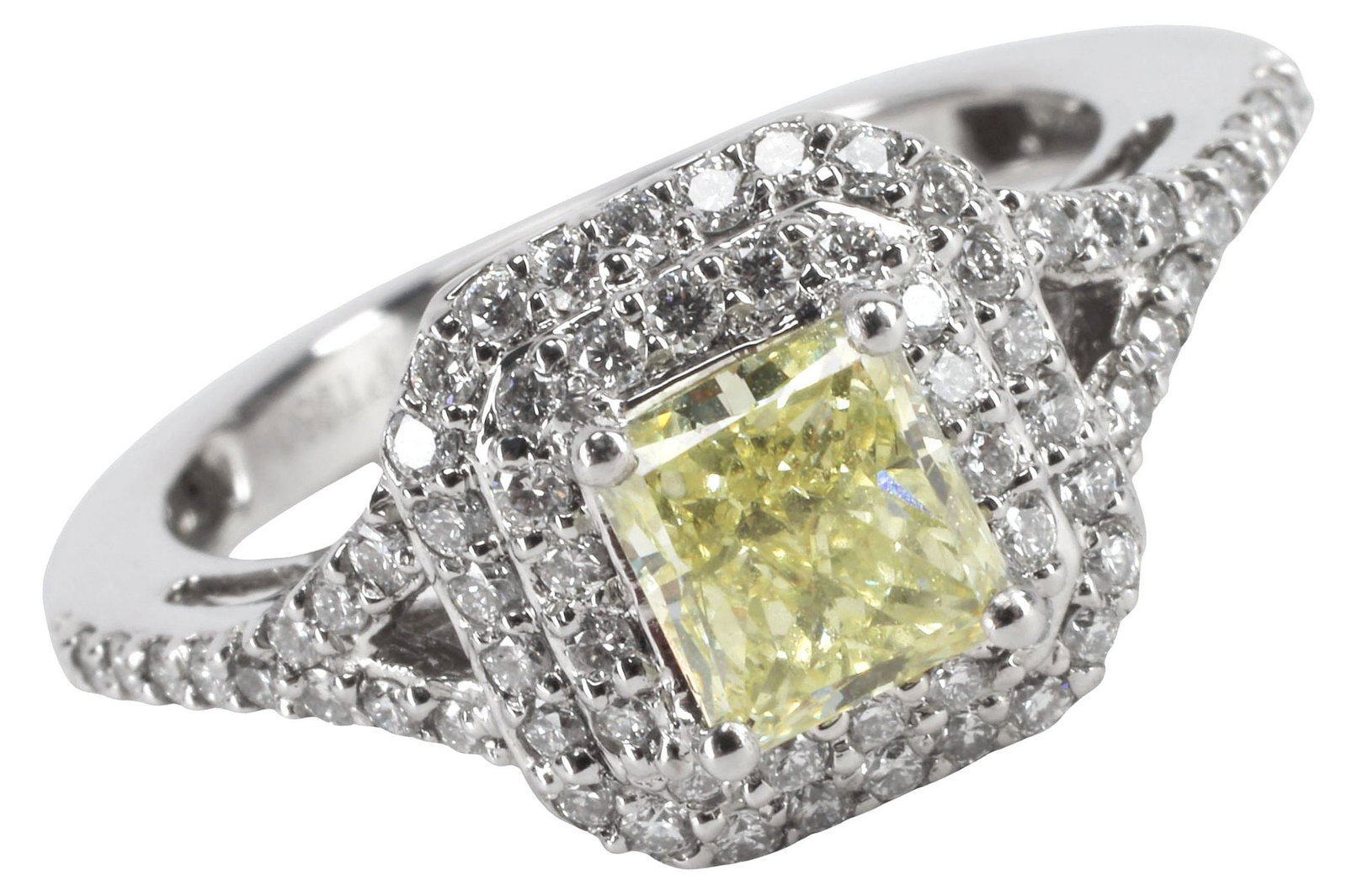 ESTATE DESIGNER RHAPSODY PLATINUM YELLOW & WHITE DIAMOND RING: Estate designer platinum and gemstone ring, Rhapsody, central radiant-cut yellow diamond, approx 0.78cts (irradiated treatment), enclosed by a double halo of round brilliant cut diamonds, and open