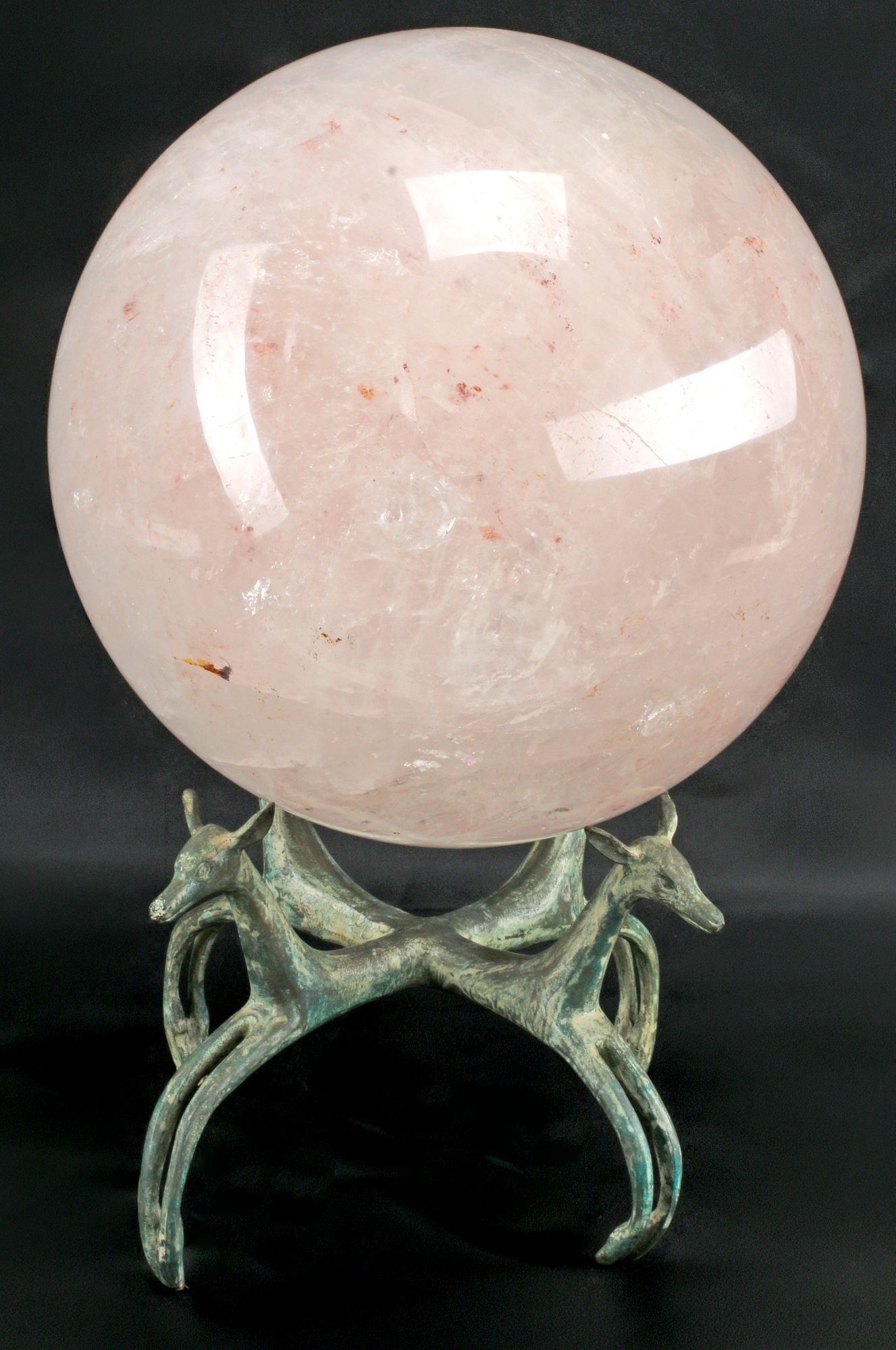 LARGE ROCK CRYSTAL SPHERE ON VERDIGRIS BRONZE DEER-FORM BASE, 17"H: Large rock crystal sphere, rising on verdigris-patinated bronze base modeled as four leaping deer, overall: approx 17"h, 10.5"diam, 66lbs