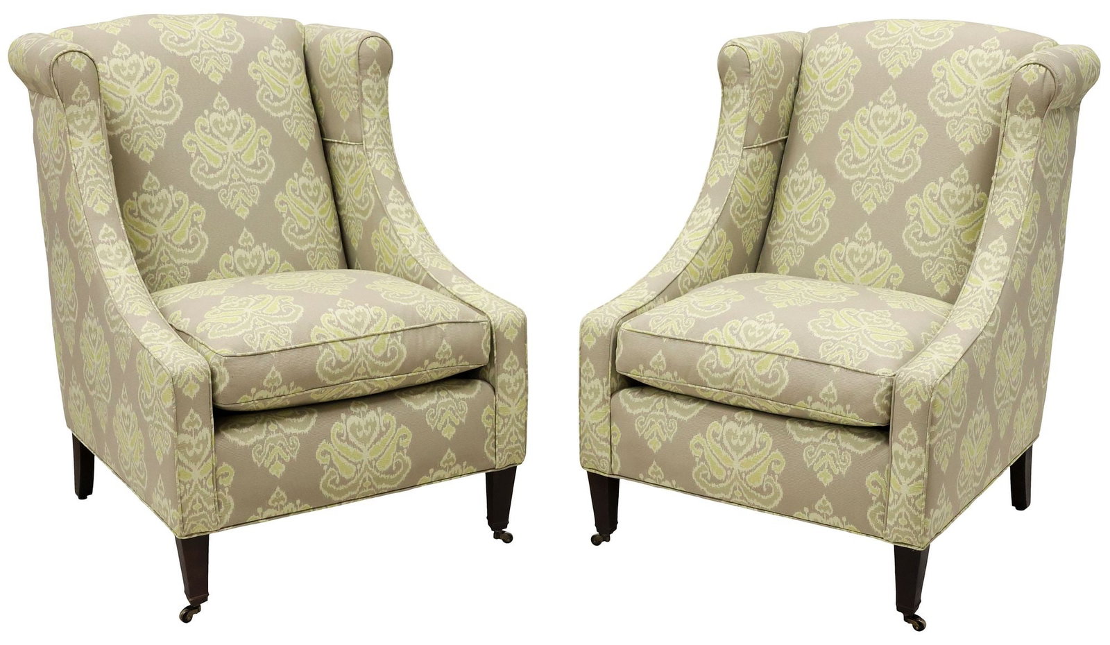 (2) CONTEMPORARY IKAT-UPHOLSTERED WINGBACK ARMCHAIRS: (pair) Contemporary upholstered wingback armchairs, 21st c., padded back, arms, and removable seat cushion in a ikat fabric upholstery, rising on frontal tapered legs, ending on casters, approx