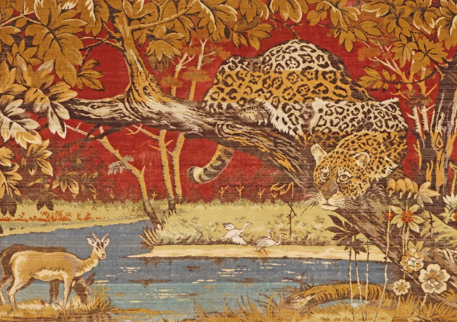 LARGE FRAMED TAPESTRY, JUNGLE LANDSCAPE WITH LEOPARD, 48.5" X 67.5": Large framed machine-woven tapestry, 20th c., depicting a lush jungle landscape with leopard perched on a tree branch, among antelope and wetland birds, sight: approx 44.5"h, 63.5"w, overall: approx 4