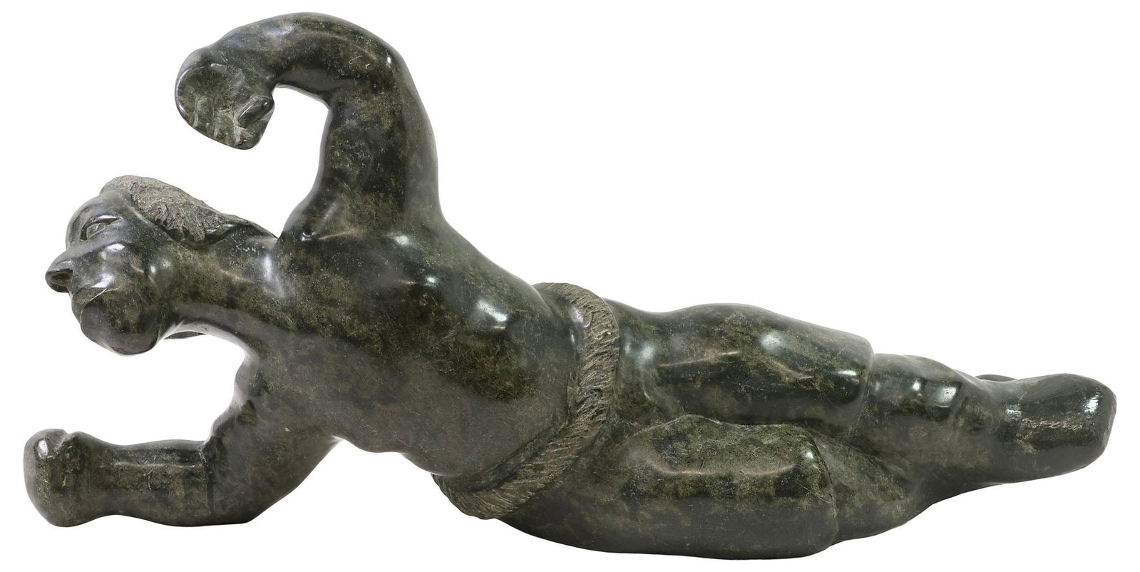 INUIT CARVED GREEN HARDSTONE SCULPTURE OF A RECLINED MAN: Inuit carved green hardstone sculpture, Reclined Figure, modeled as a man laying on his side, with his arm raised, lower arm and foot intact with possible restoration, approx 11.5"h, 23"w, 6.5"d, 25lb