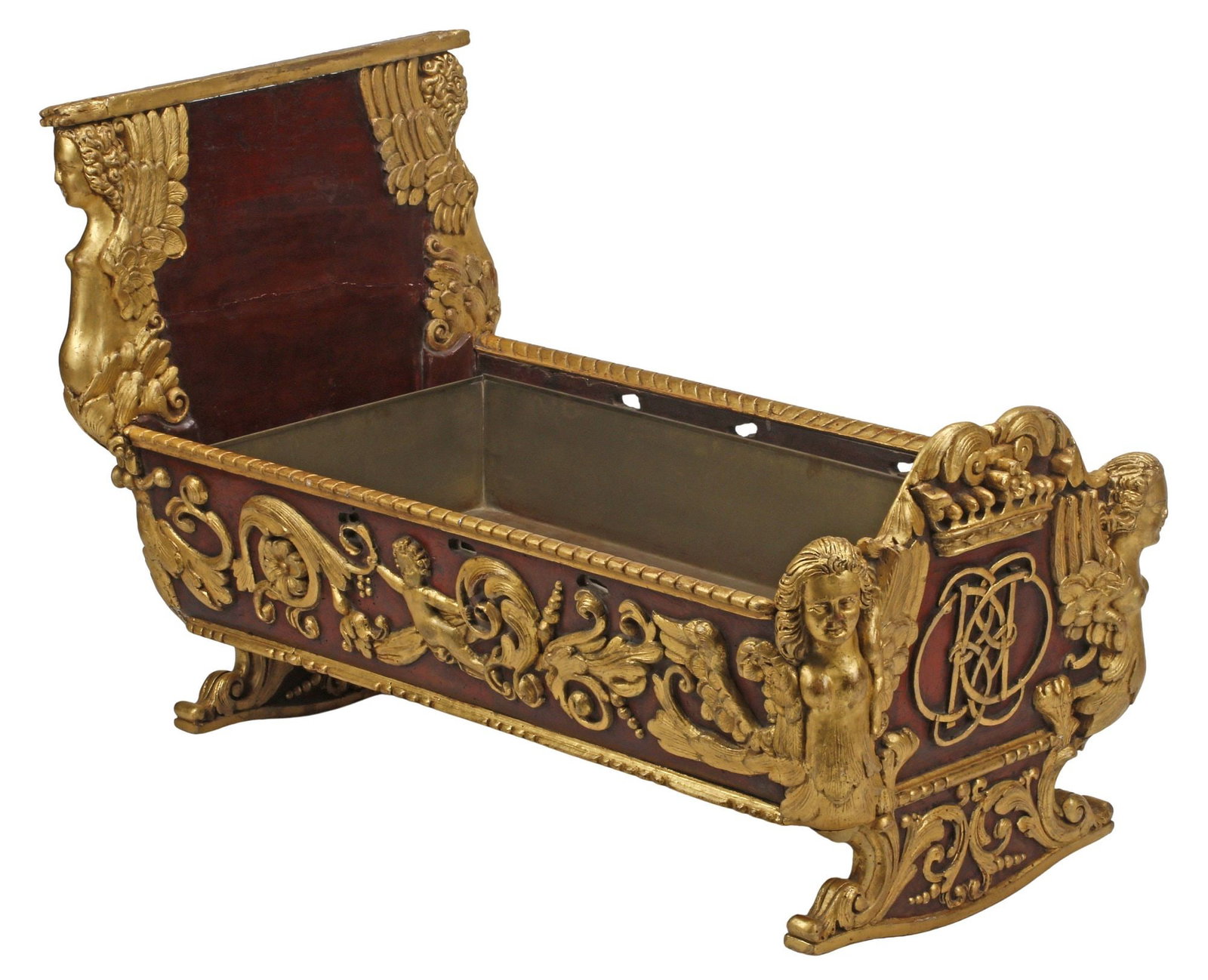 ITALIAN PARCEL-GILT & PAINTED CARVED WOOD CHILD'S CRADLE, 19TH C.: Italian parcel-gilt and paint-decorated carved wood cradle, late 19th c., with winged cherubs, flowers, and scrolling foliates, one end with crowned monogram, interior with removable metal liner,