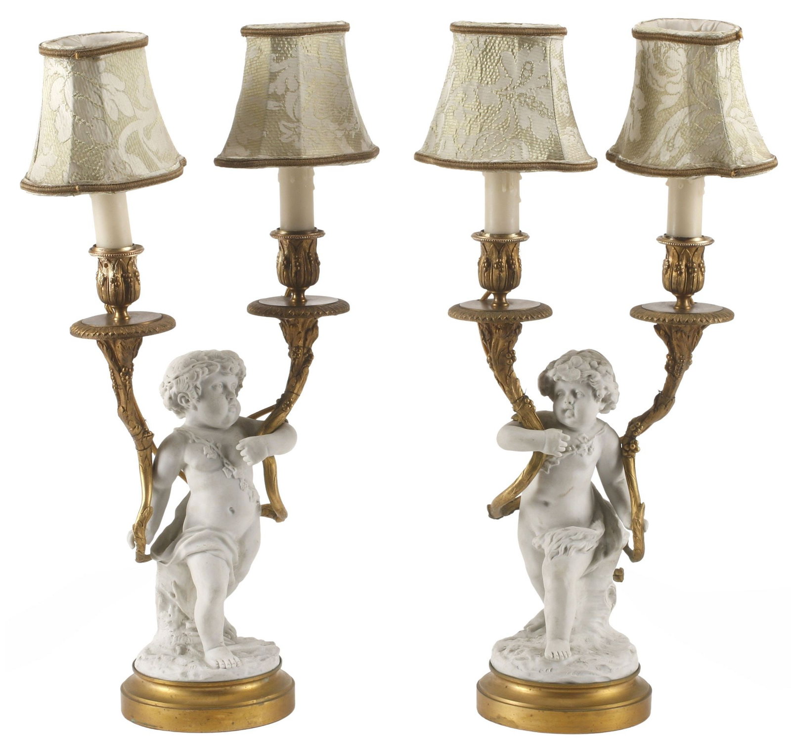 (2) FRENCH ORMOLU & PORCELAIN FIGURAL CHERUB 2-LT CANDELABRA LAMPS: (pair) French bronze dore and bisque porcelain two-light candelabra, 19th c., now electrified, each modeled as a draped putto holding two cornucopias aloft, terminating on vasiform bobeches and faux c
