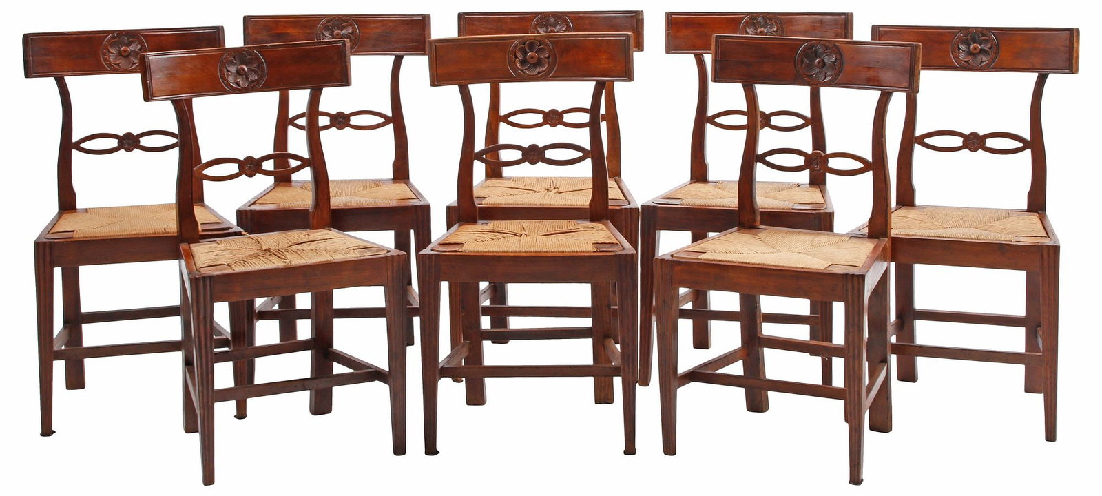 (8) NEOCLASSICAL STYLE CARVED WALNUT RUSH-SEAT DINING CHAIRS: (lot of 8) Neoclassical style walnut dining chairs, 19th c., each having back rail with central floral roundel, above pierced splat and rush seat, rising on tapering squared supports joined by box str