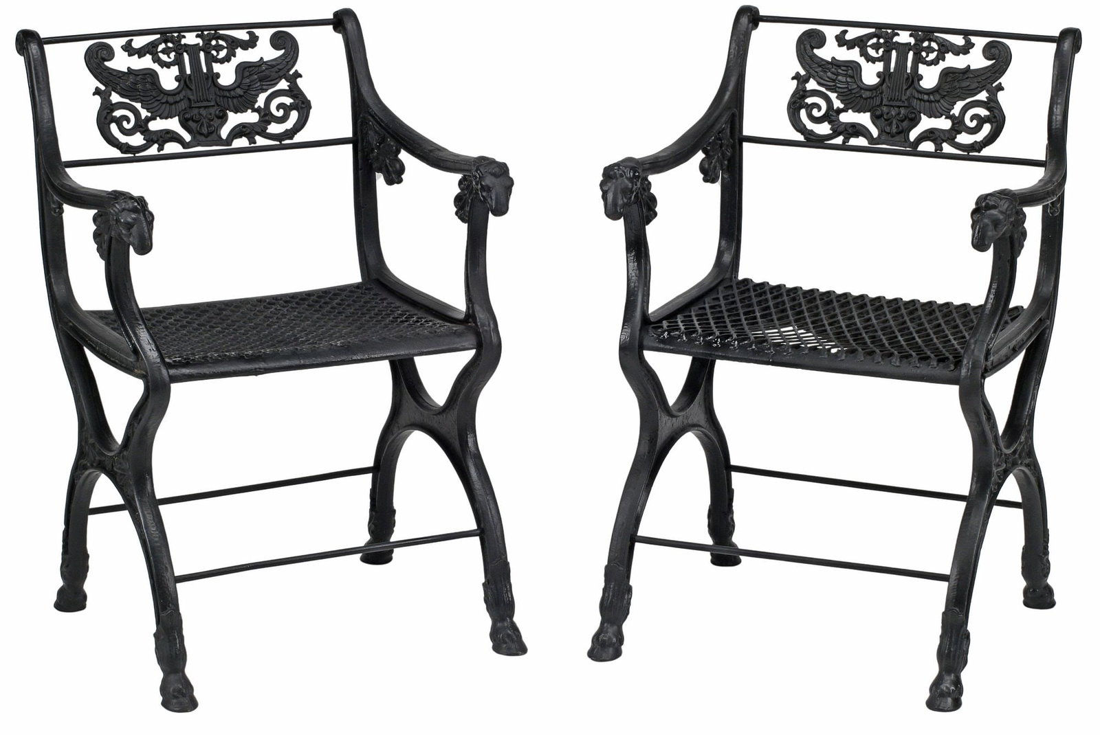 (2) NEOCLASSICAL GREEK REVIVAL CAST IRON OUTDOOR CURULE ARMCHAIRS: (pair) Neoclassical Greek Revival style cast iron outdoor patio armchairs, each pierced splat with winged lyre and scrolling foliates, ram's heads handholds, over latticework seat, on stretcher-joined