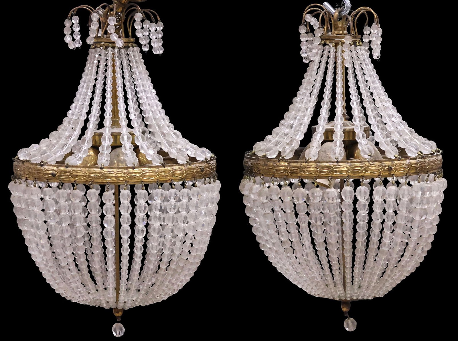 (2) ITALIAN EMPIRE STYLE SAC-DE-PEARL CRYSTAL & GILT METAL CHANDELIERS: (pair) Italian Empire style sac-de-pearl four-light chandeliers, 20th c., each with gilt-metal frame with chased geometric patterning, hung with crystal beaded swags, enclosing four lights, over beade