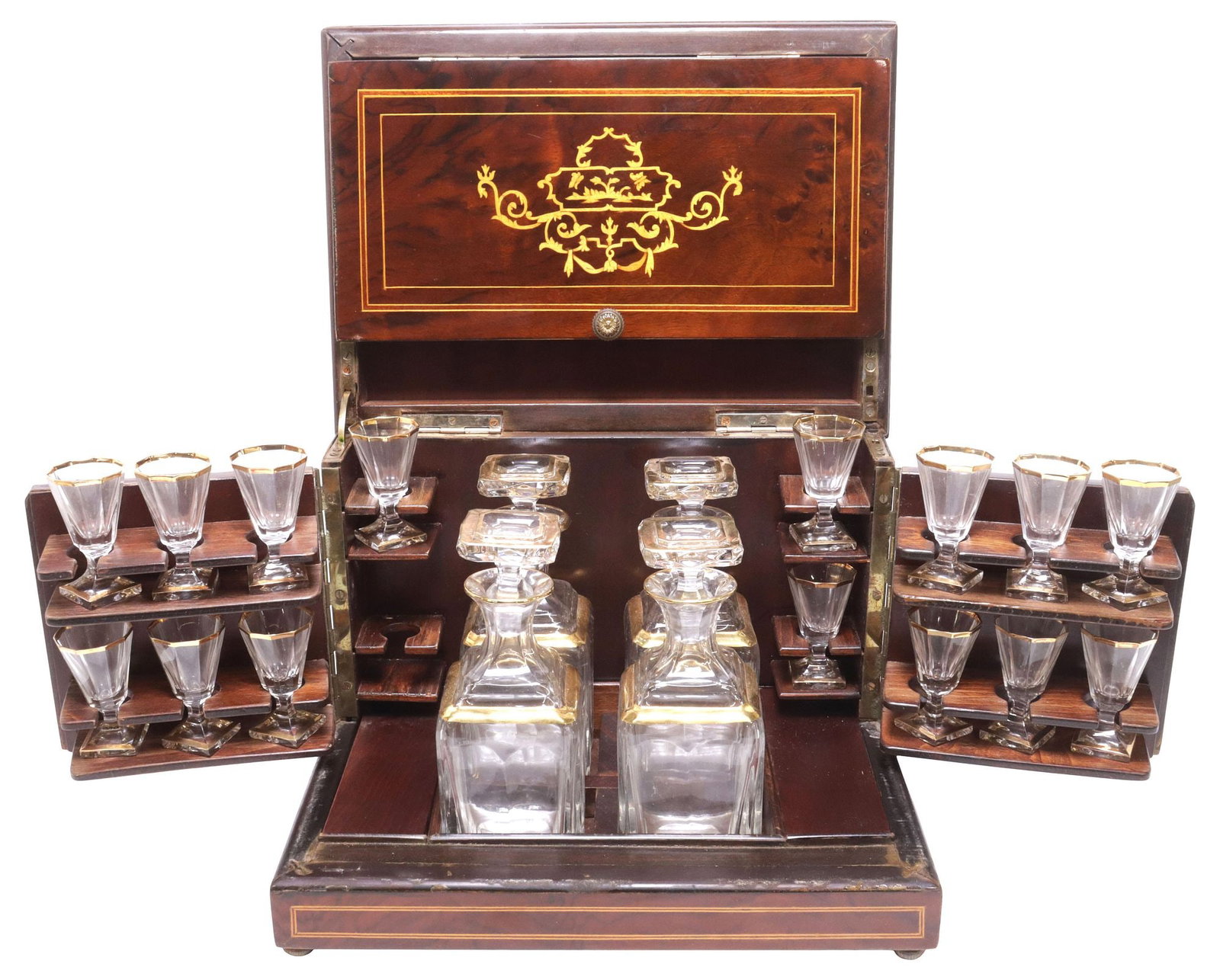FRENCH NAPOLEON III MARQUETRY & MAHOGANY CAVE A LIQUEUR / TANTALUS SET: French Napoleon III figured mahogany tantalus set / cave a liqueur, 19th c., hinged case with scrolling foliate marquetry and central vacant cartouche, inlaid stringwork and banded trim, enclosing cra