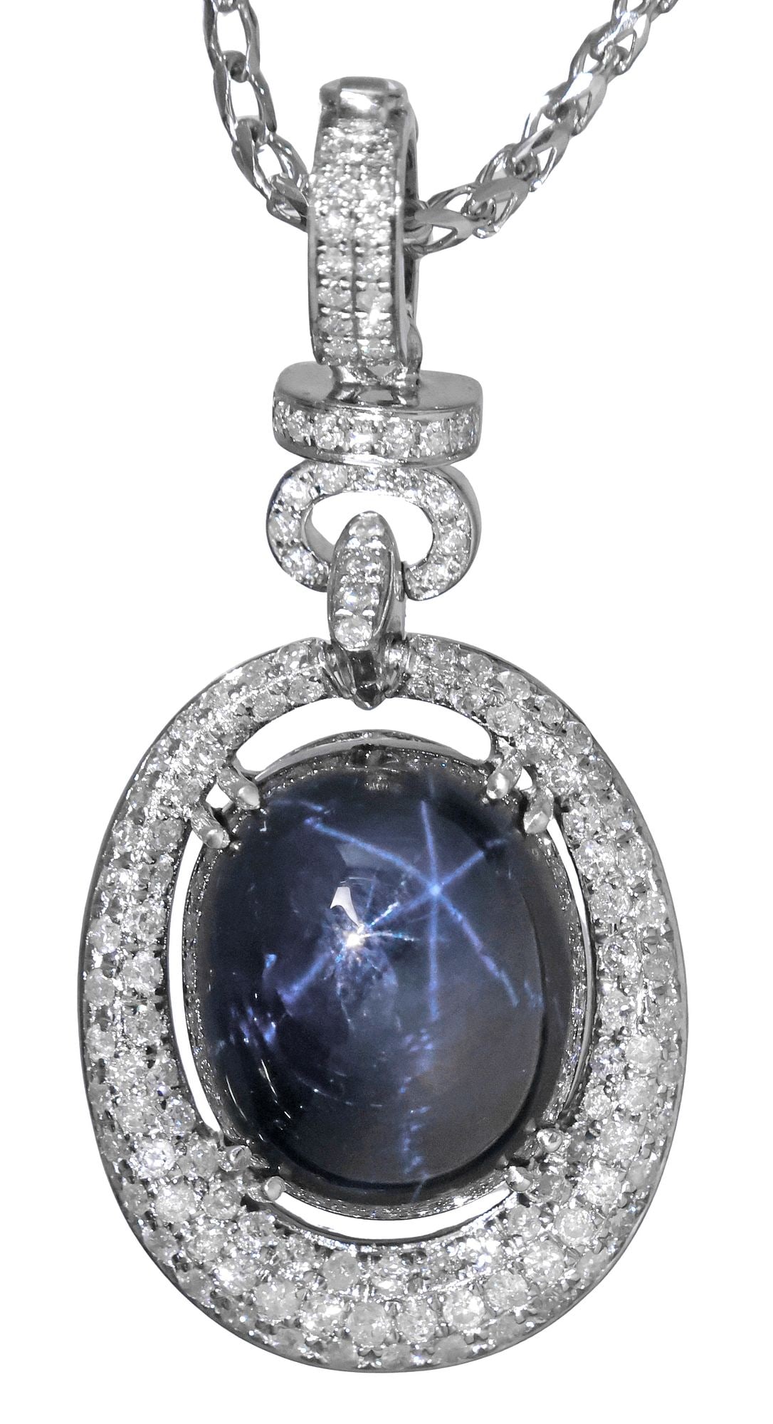 ESTATE ORIANNE 14KT WG, 14.70CT STAR SAPPHIRE & DIAMOND PENDANT NECKLACE: Estate designer 14kt white gold and gemstone enhancer pendant, Orianne, central star sapphire oval cabochon, approx 14.70ct, in suspended bezel, framed by numerous small round diamonds and