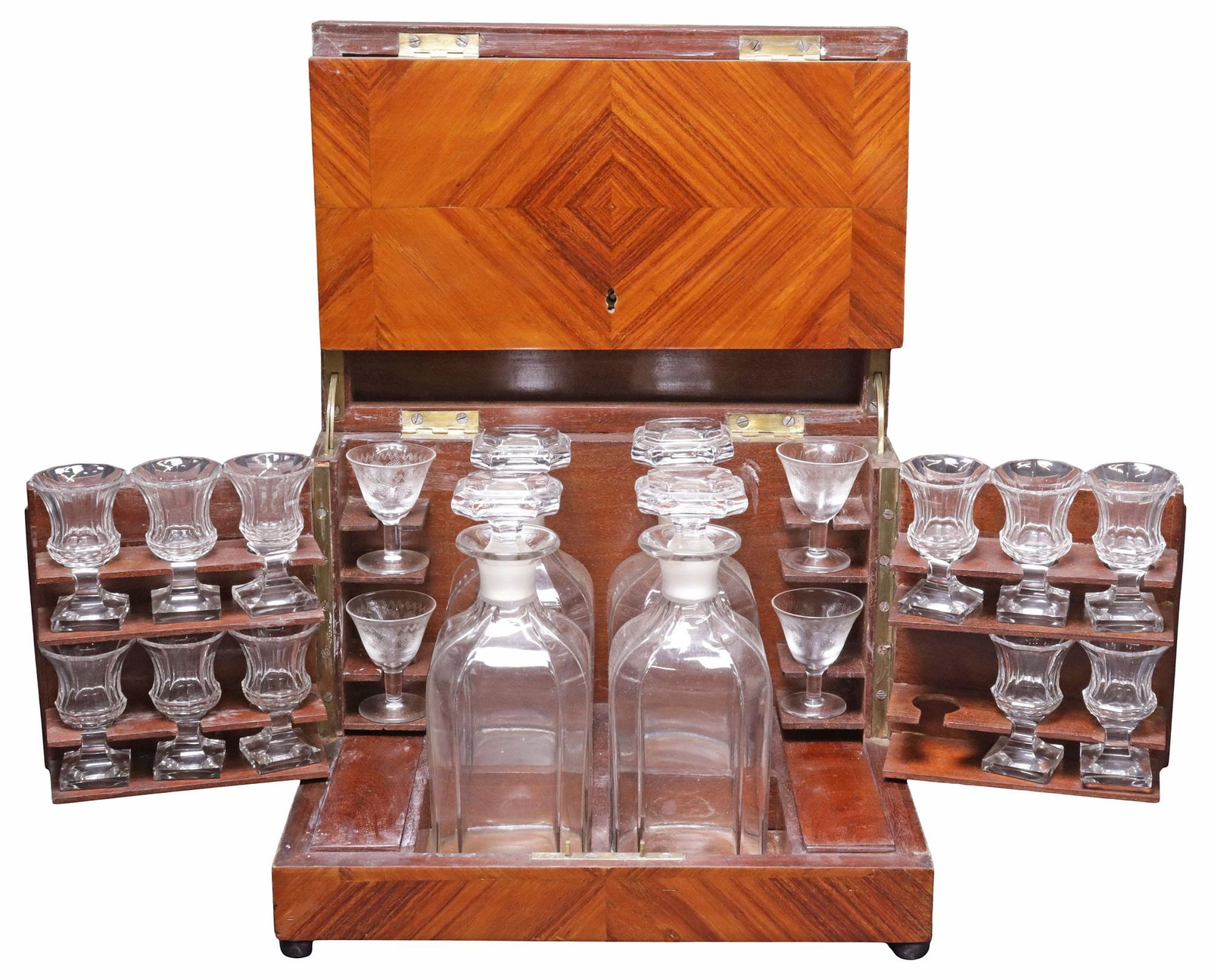 FRENCH MATCHED-VENEER CAVE A LIQUEUR / TANTALUS SET: French cave-a-liqueur/ tantalus set, 19th c., hinged rectangular case finished in matched mahogany veneers, with gilt-metal trim, revealing fitted interior with (four) cut crystal decanters and