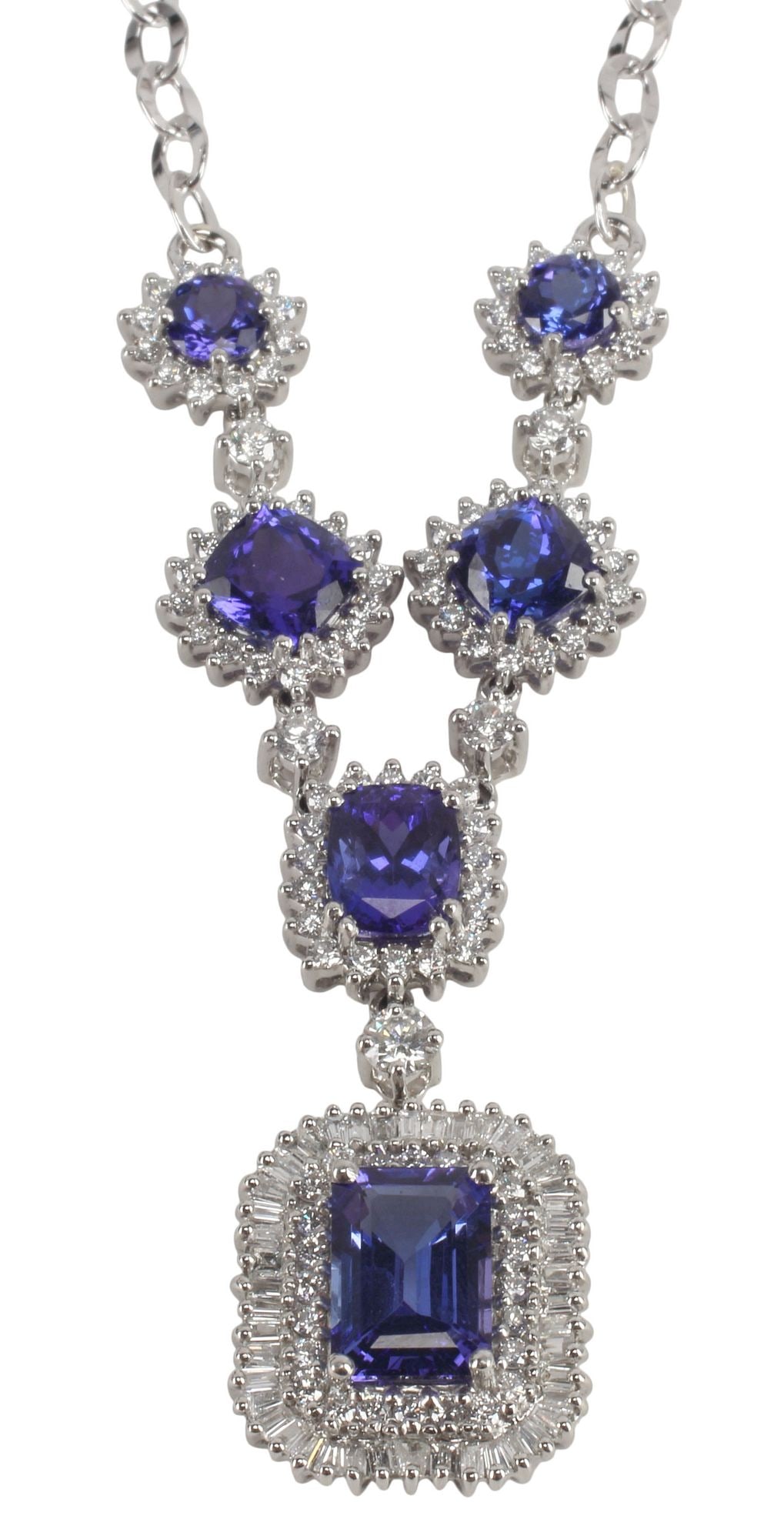ESTATE DESIGNER RHAPSODY 12.32CT TANZANITE & DIAMOND PENDANT NECKLACE: Estate designer platinum, 14kt white gold gemset necklace, Rhapsody, featuring articulated prong set tanzanite and diamond set stations in platinum settings, including (one) emerald-cut, (one)