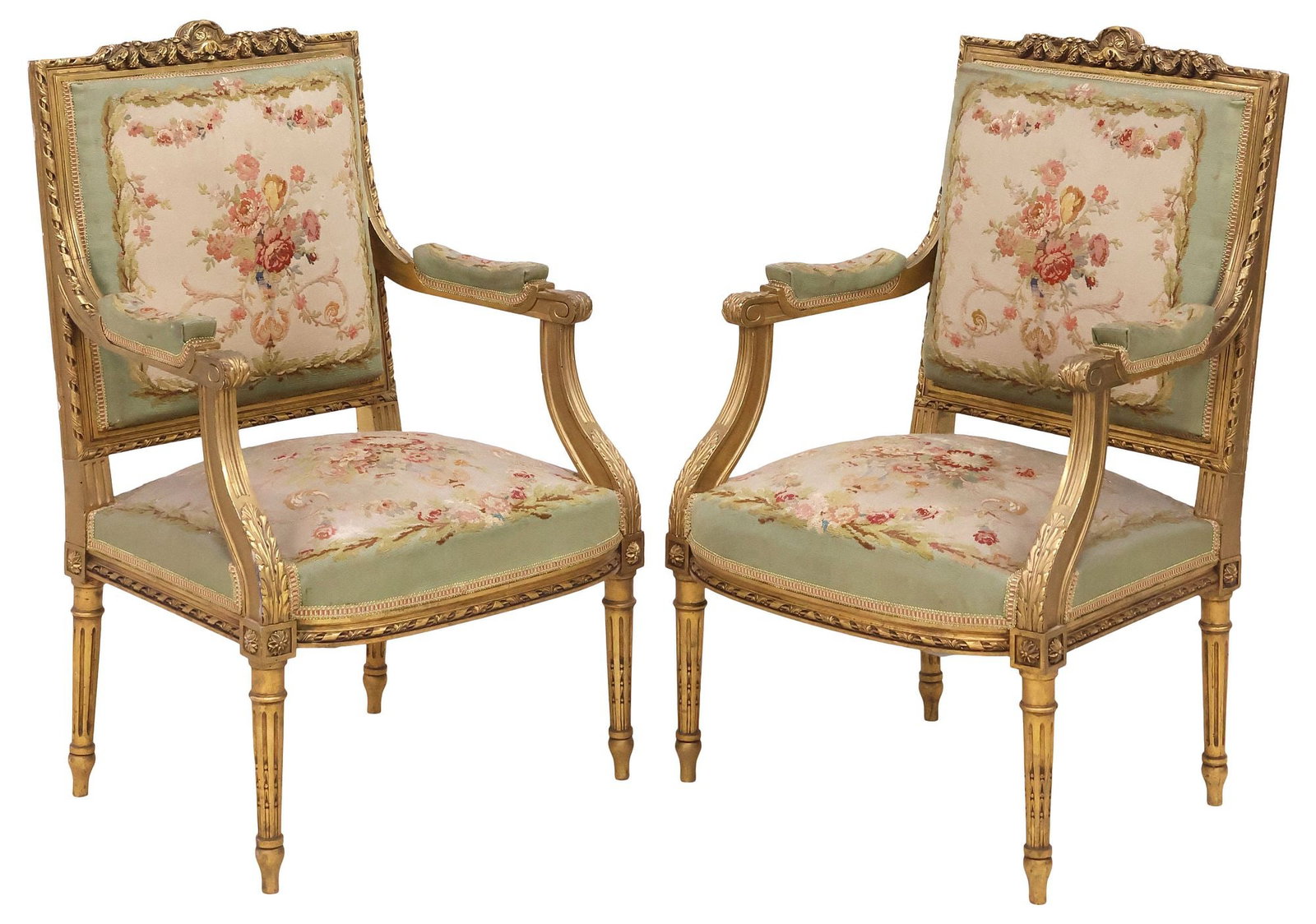 (2) FRENCH LOUIS XVI STYLE TAPESTRY-UPHOLSTERED GILTWOOD ARMCHAIRS: (pair) French Louis XVI style giltwood armchairs/ fauteuils, late 19th c., molded crest with laurel swags and ribbon twist trim, padded back, arms, and seat in a floral woven tapestry upholstery, with