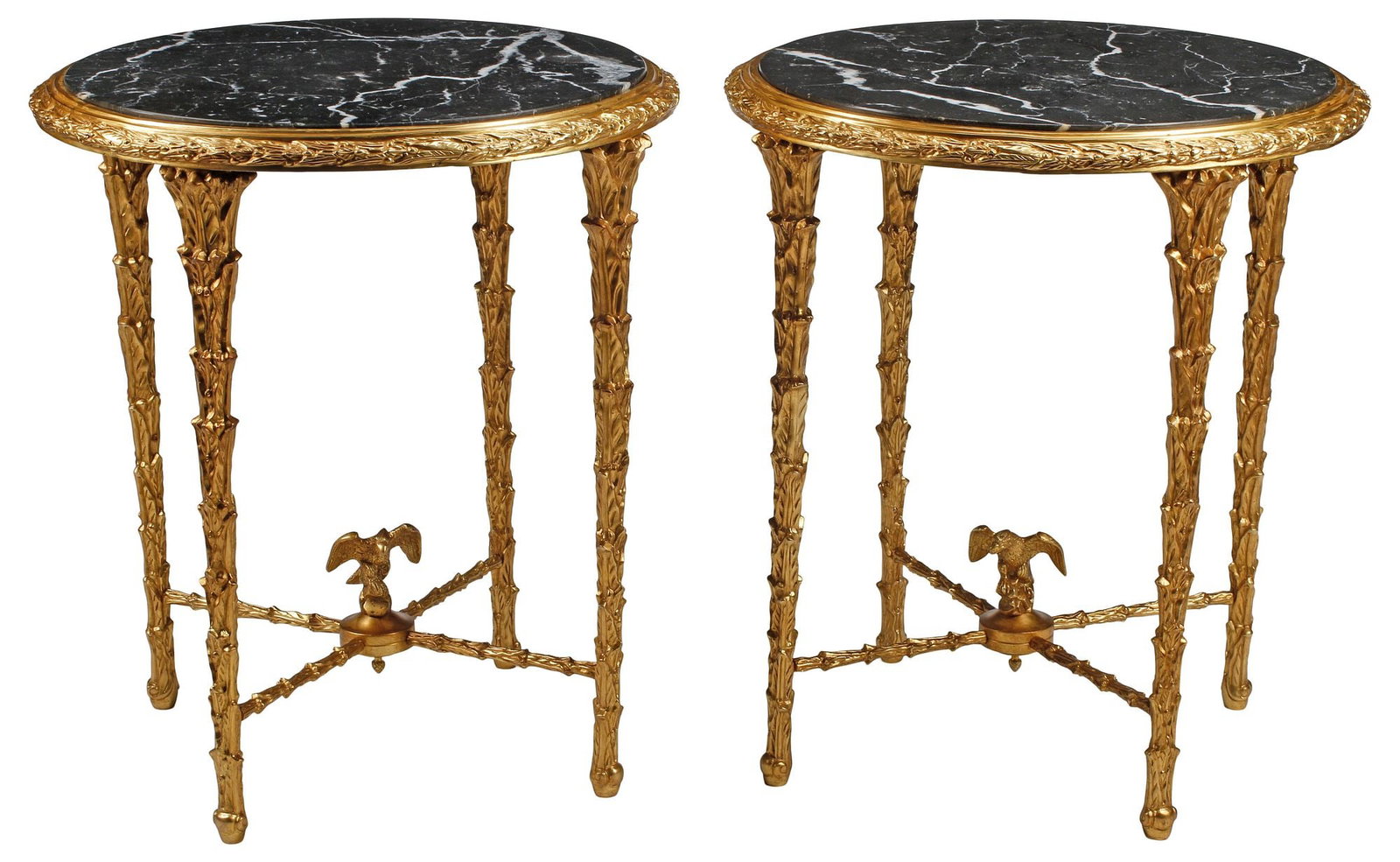 (2) REGENCE STYLE MARBLE-TOP ORMOLU GUERIDONS / SIDE TABLES: (pair) Regence style bronze dore gueridons/ side tables, each having inset black marble top, rising on tapering foliate supports, joined by winged eagle finial, approx 28"h, 25"diam