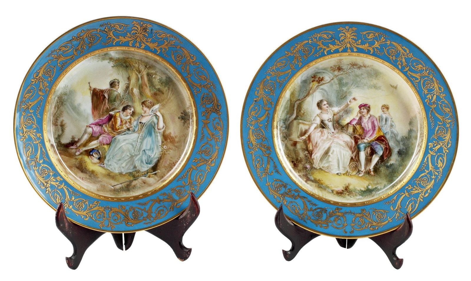 (2) FINE FRENCH SEVRES STYLE PARCEL-GILT BLEU CELESTE PORCELAIN SERVING PLATTERS: (lot of 2) Fine French Sevres style parcel-gilt porcelain serving platters, 19th c., each with unique hand-painted reserve depicting courting couples in forest landscape, bearing the artist's signatur
