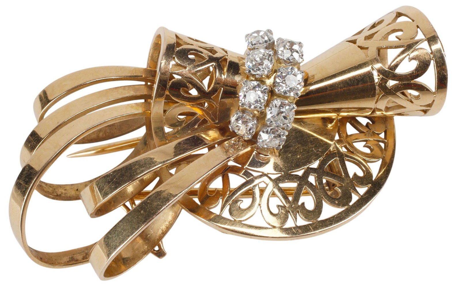 ESTATE RETRO 18KT YG, PLATINUM & DIAMOND DRESS CLIP BROOCH, 23.6 GRAMS: Estate Continental Retro 18kt yellow gold and platinum (tested) dress clip brooch, sculptural pierced and scroll design, set with (eight) old mine cut diamonds, approx 1.30cttw, average color: G-H, av