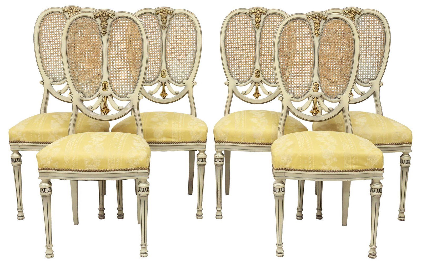 (6) FRENCH LOUIS XVI STYLE CANED & UPHOLSTERED PAINTED DINING CHAIRS: (lot of 6) French Louis XVI style white-painted and parcel-gilt dining chairs, early 20th c., oval backs with paneled caning and foliate accents, padded seat in a floral jacquard upholstery with