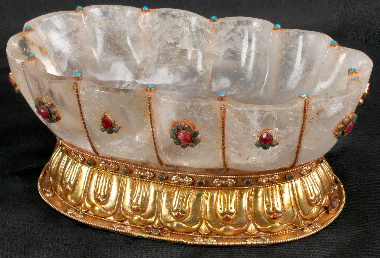 GEM-ENCRUSTED & ORMOLU-MOUNTED FLUTED ROCK CRYSTAL BOWL: Gem-encrusted fluted rock crystal bowl, with gilt-bronze mounts and semi-precious stones, rising on ovular foot, approx 4"h, 9"w, 5.5"d, 4.25lbs