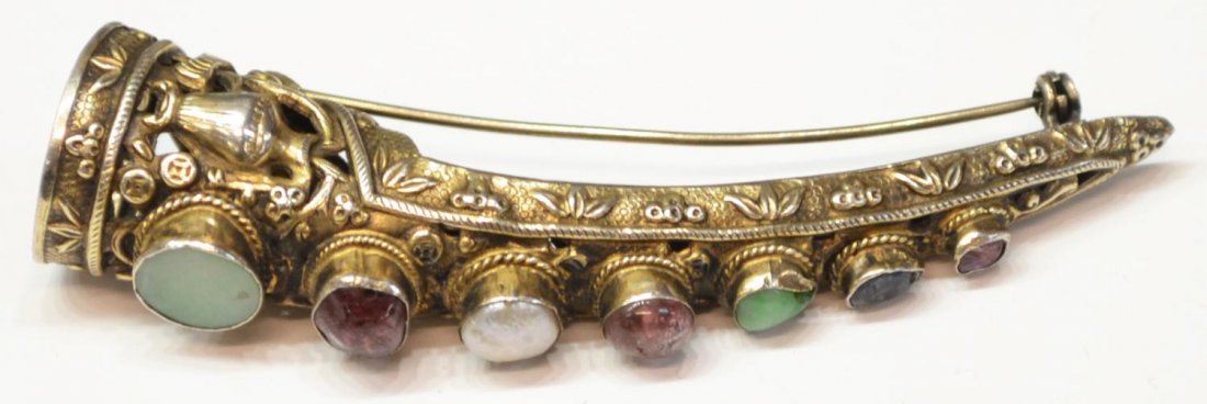 CHINESE SILVER & SEMI-PRECIOUS NAIL GUARD PENDANT: Chinese silver fingernail guard having repousse foliate accents, mounted with semi-precious cabochons, now with pin fastener, marked silver underfoot, 3"l, .25lb (for shipping purposes) Start Price: $