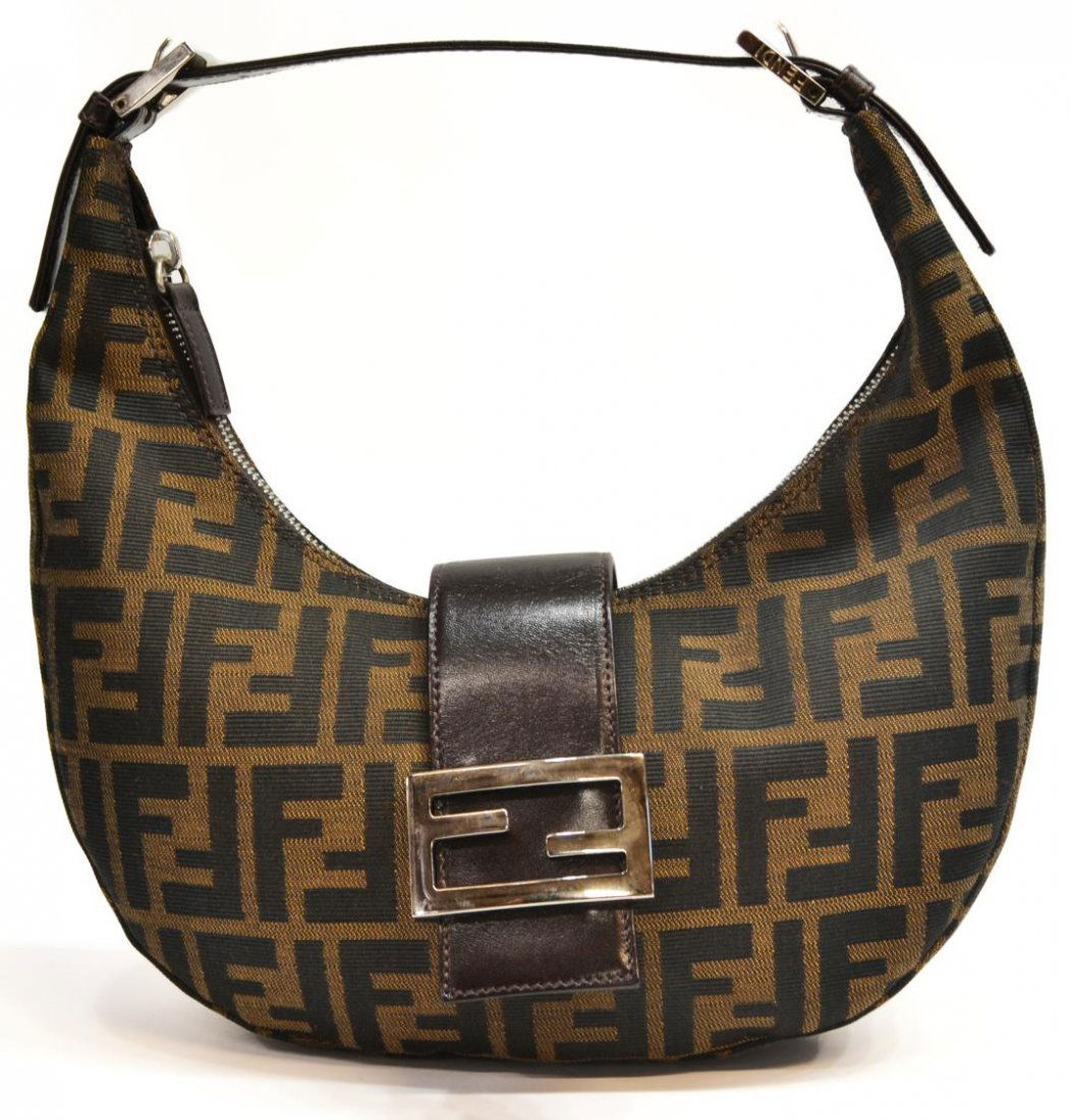 LADIES FENDI MONOGRAM CANVAS HANDBAG: Fendi 'Baguette' style monogram canvas handbag, the clasp with silver tone metal hardware and logo mark, lined interior with single pocket, approx 9.5"h, 10.5"w, 0.75lbs Start Price: $100.00