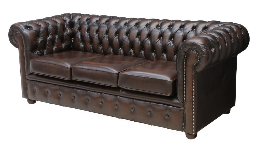 CHESTERFIELD BROWN LEATHER BUTTONED SOFA: Chesterfield brown leather upholstered sofa, buttoned and tufted back affixed with three seat cushions, resting on bun feet, 29"h, 75"w, 32"d Start Price: $600.00
