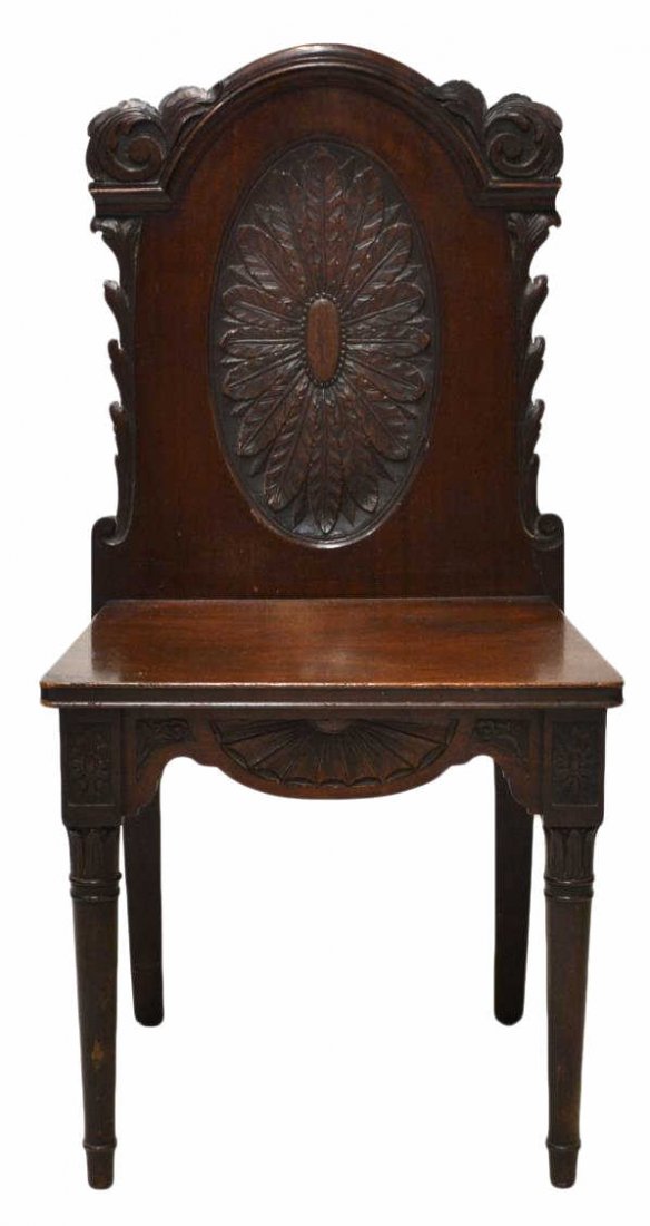 WELL CARVED VICTORIAN MAHOGANY HALL CHAIR: Victorian mahogany hall chair, excellent carving throughout, foliated uprights join the arched crest, over a solid back with detailed central oval, solid seat raised on tapered legs of cylindrical for