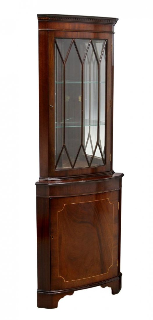 ENGLISH INLAID MAHOGANY CORNER DISPLAY CABINET: English mahogany corner cabinet, the display top having mullioned glazed door, interior glass shelves, curved base with string inlay opening to a single shelf, on bracket feet, 71.5", 25.75"w, 18"d St