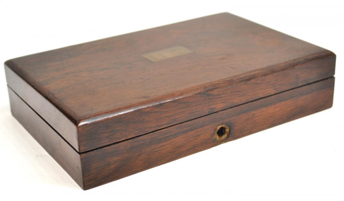 ENGLISH DRAFTING TOOLS, FITTED ROSEWOOD BOX: Diminutive English rosewood box, a drafting kit, the top set with central brass cartouche, initialed H.C., hinged top opening to fitted interior, accompanied by various metal drafting instruments for 