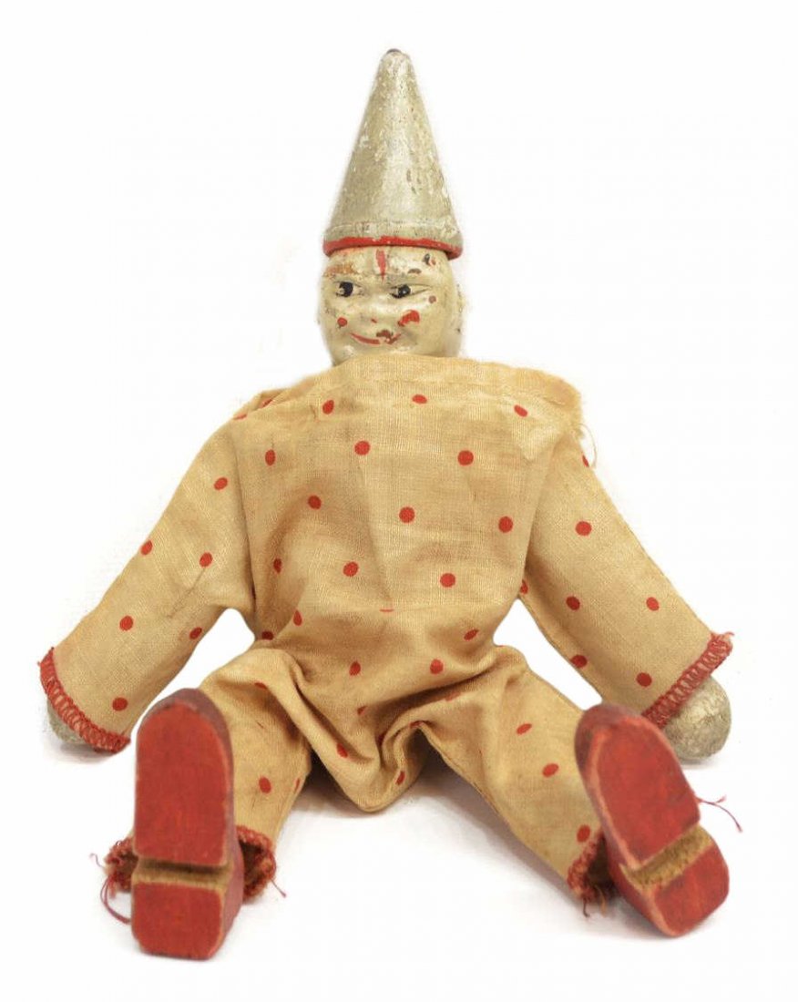 VINTAGE ALBERT SCHOENHUT WOOD CIRCUS CLOWN: Vintage Albert Schoenhut carved wood circus clown, modeled after Humpty Dumpty Troup performers from the early 20th century, clad in a red polka dot onesie and pointed hat, loss to one ear, wear due t