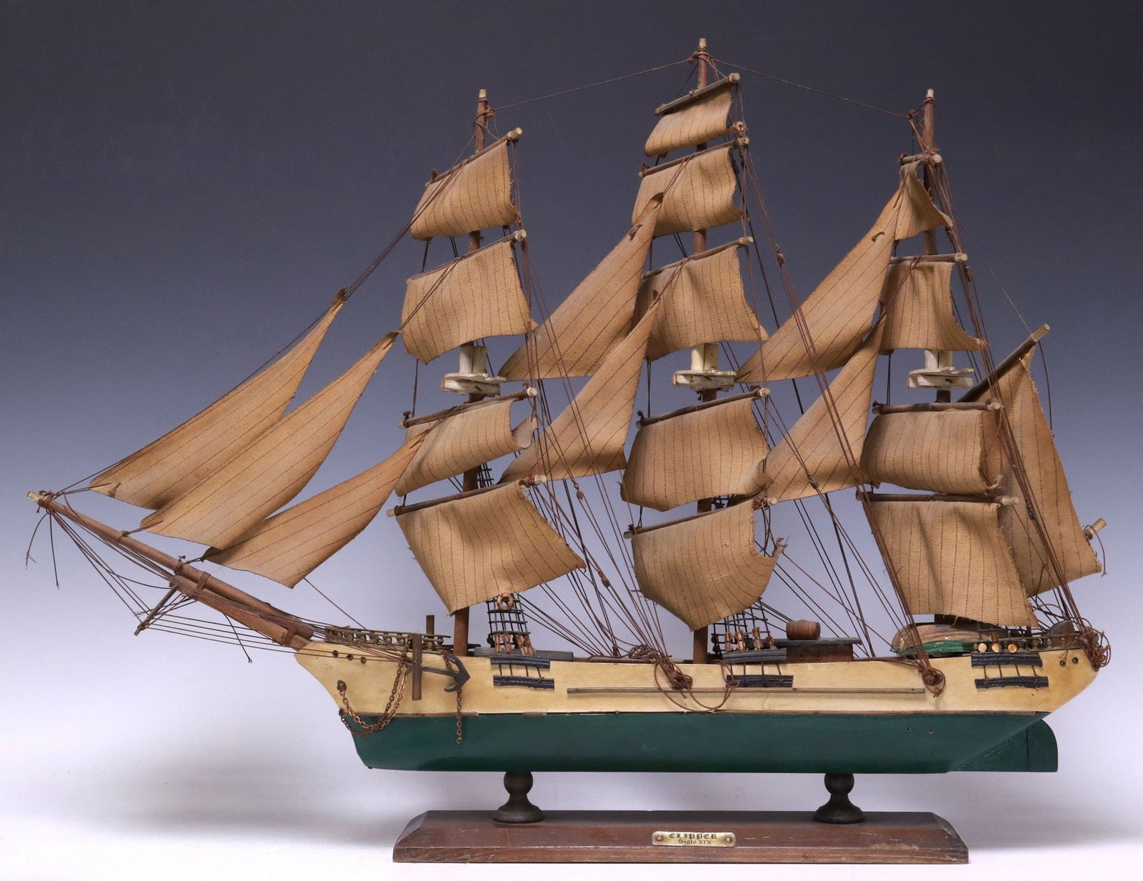 MODEL SAILING CLIPPER MERCHANT SHIP ON STAND, 21"H: Model sailing ship, 20th c., depicting a nineteenth-century clipper merchant ship, single-hull vessel with full rigging and fabric sails, rising on wood base, fitted with metal plaque inscribed "Clipp