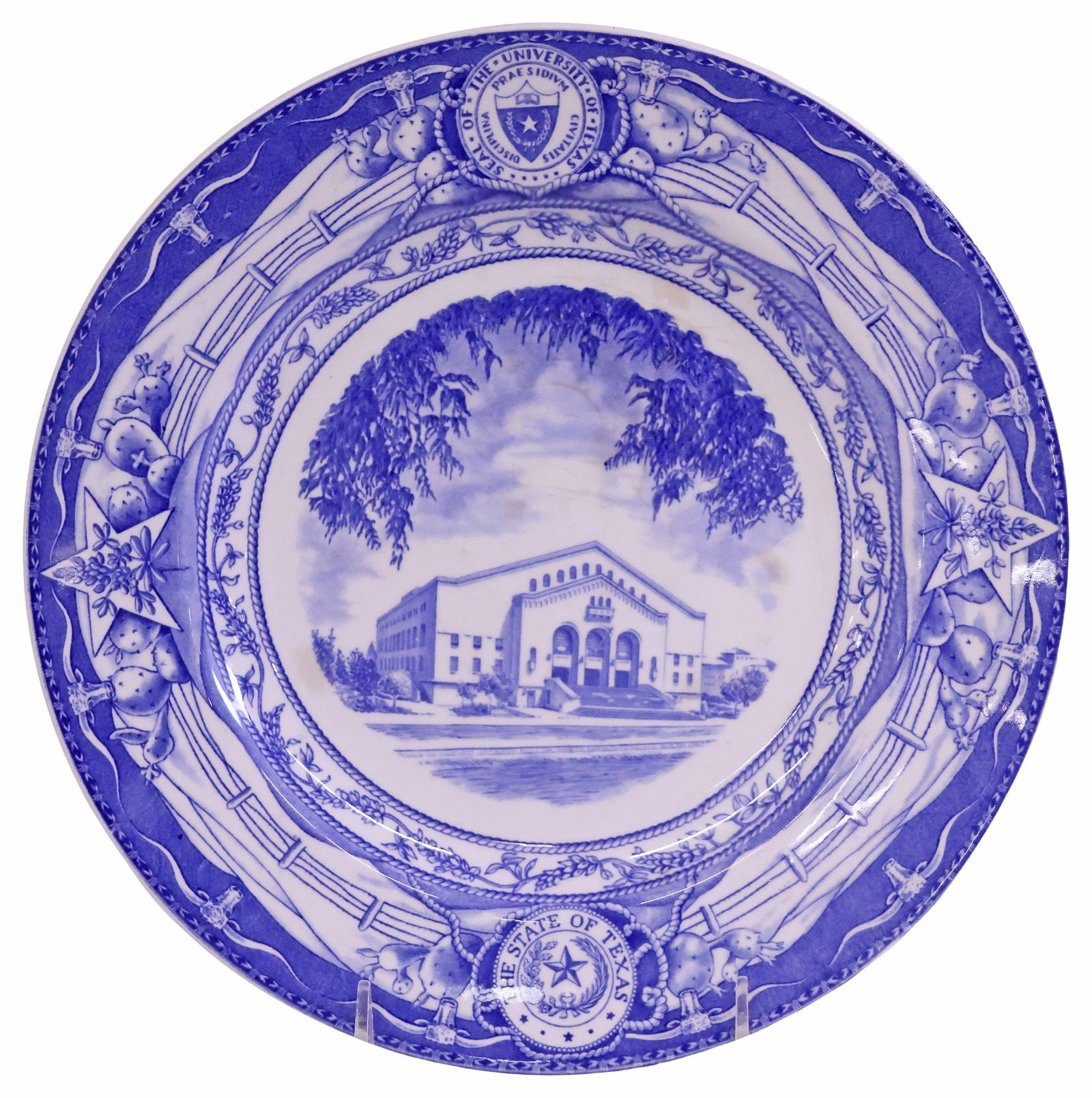 SCARCE BLUE WEDGWOOD UT 'GREGORY GYMNASIUM' COMMEMORATIVE PLATE: Scarce Wedgwood commemorative University of Texas plate, blue on white ground, a detailed transfer of "Gregory Gymnasium," a rope and bluebonnet design frame the scene with the University of Texas sea