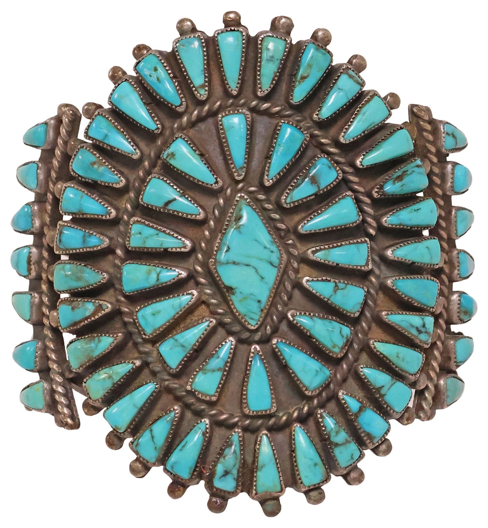 SIGNED NATIVE AMERICAN SILVER & PETIT POINT TURQUOISE CUFF BRACELET: Native American silver (content unknown) cuff bracelet, medallion with central diamond-form turquoise stone, encircled by medallion set with (forty-eight) triangular cabochons, sunburst element with s