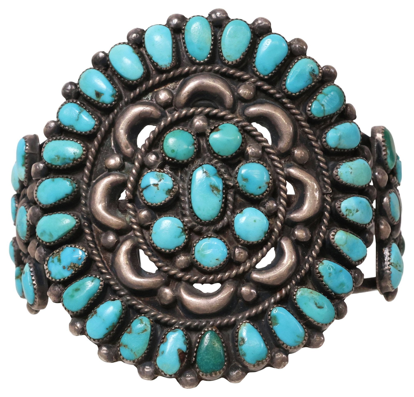 SIGNED NATIVE AMERICAN SILVER & TURQUOISE CLUSTER CUFF BRACELET: Native American silver (content unknown) cuff bracelet, central roundel set with thirty-four turquoise cabochons, rope twist and openwork scalloped trim, flanked by half-moon element at either side wi