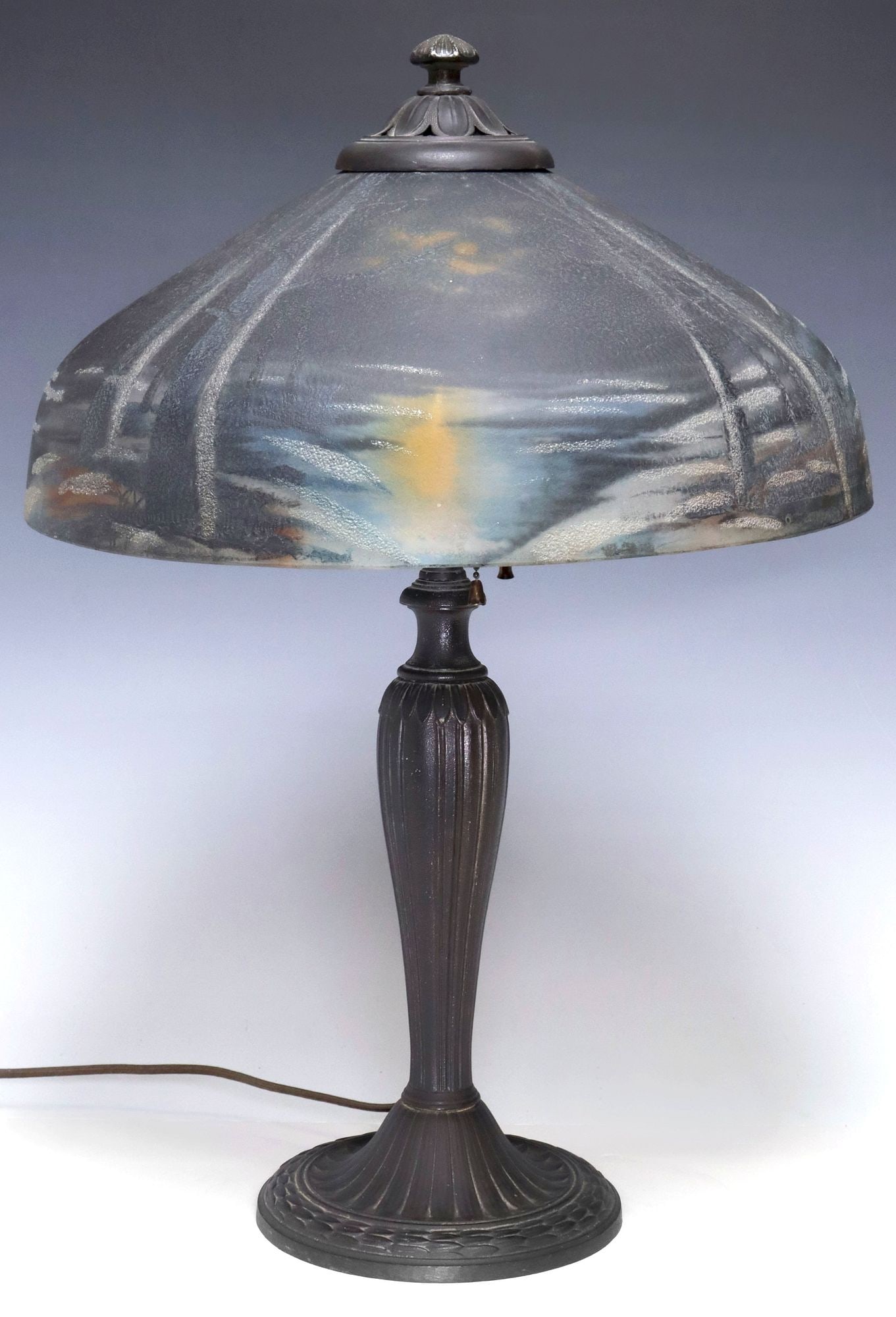 A&R COMPANY ART DECO PERIOD REVERSE-PAINTED GLASS 2-LT TABLE LAMP: American Art Deco patinated metal and art glass two-light table lamp, A&R Company, Newark, New Jersey, c.1920s, domed glass shade with reverse-painted of a snowy lakeside landscape at twilight, enclos