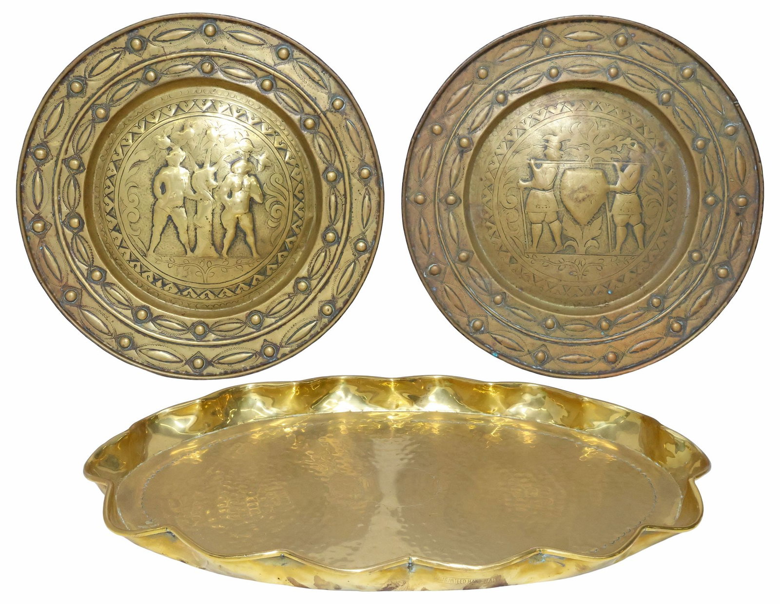 (3) GERMAN BRASS REPOUSSE BIBLICAL ALMS DISHES & EDWARDIAN SERVING TRAY: (lot of 3) European brass table items, including: (2) German repousse alms dishes, a near pair, each with dotted geometric border, centering figures in low relief, (one) depicting Adam and Eve standin