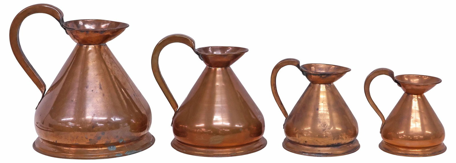 (4) ENGLISH VICTORIAN GRADUATED COPPER MEASURING / HARVEST JUGS: (lot of 4) English Victorian graduated copper harvest jugs, late 19th c., ranging from one pint to one gallon, inspection stamp marked HR, largest: approx 6.75"h, 5.5"w, 6.5"d, smallest: approx 12"h, 