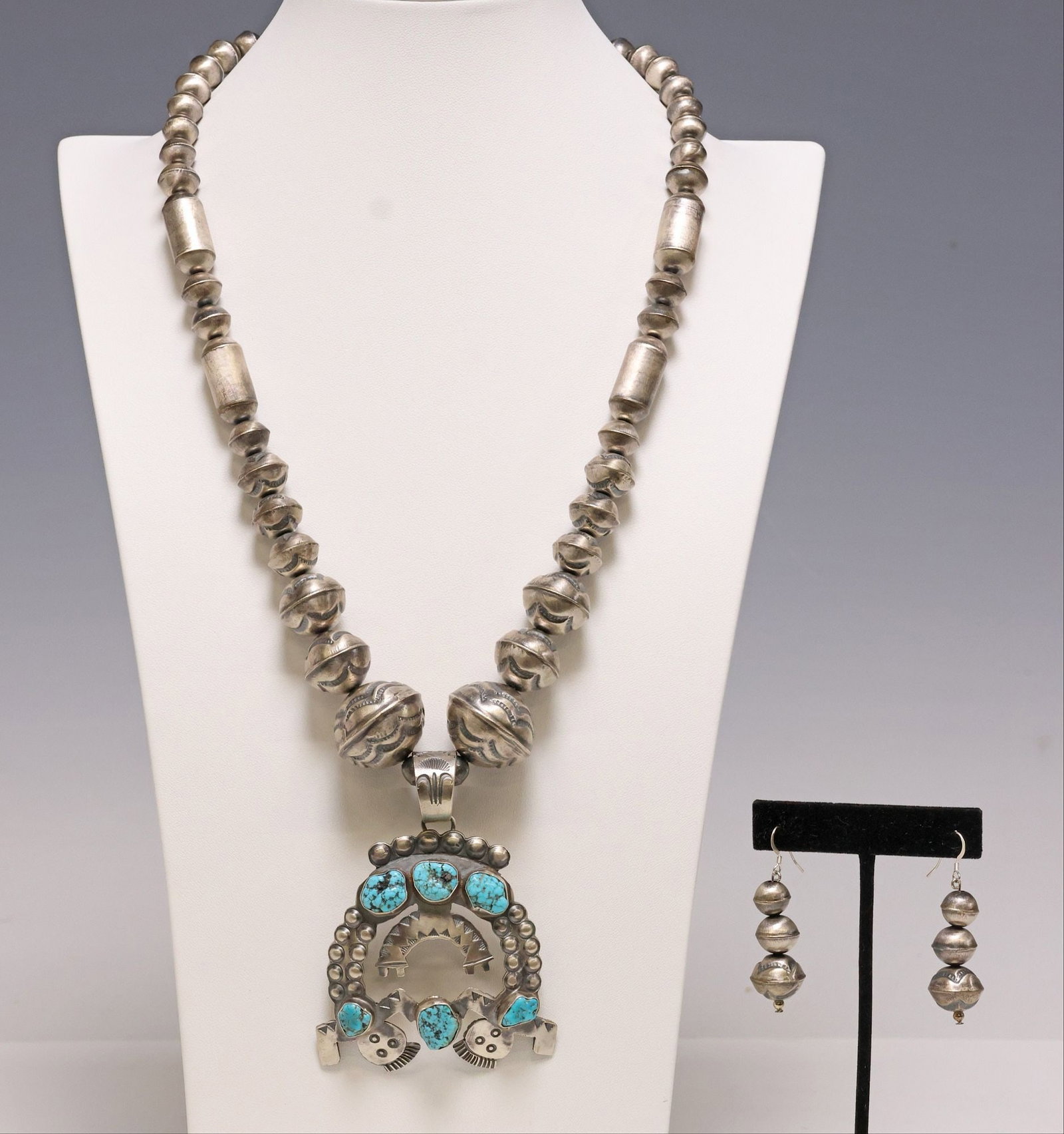 (2) SHAWN CAYATINETO NAVAJO NAJA PENDANT NECKLACE & SILVER BENCH BEAD EARRINGS: (lot of 2) Native American sterling and silver (content unknown) jewelry set, including: (1) pendant necklace, pendant signed SC (Shawn Cayatineto, Navajo/ Dine, 20th c.), sterling silver naja with (t