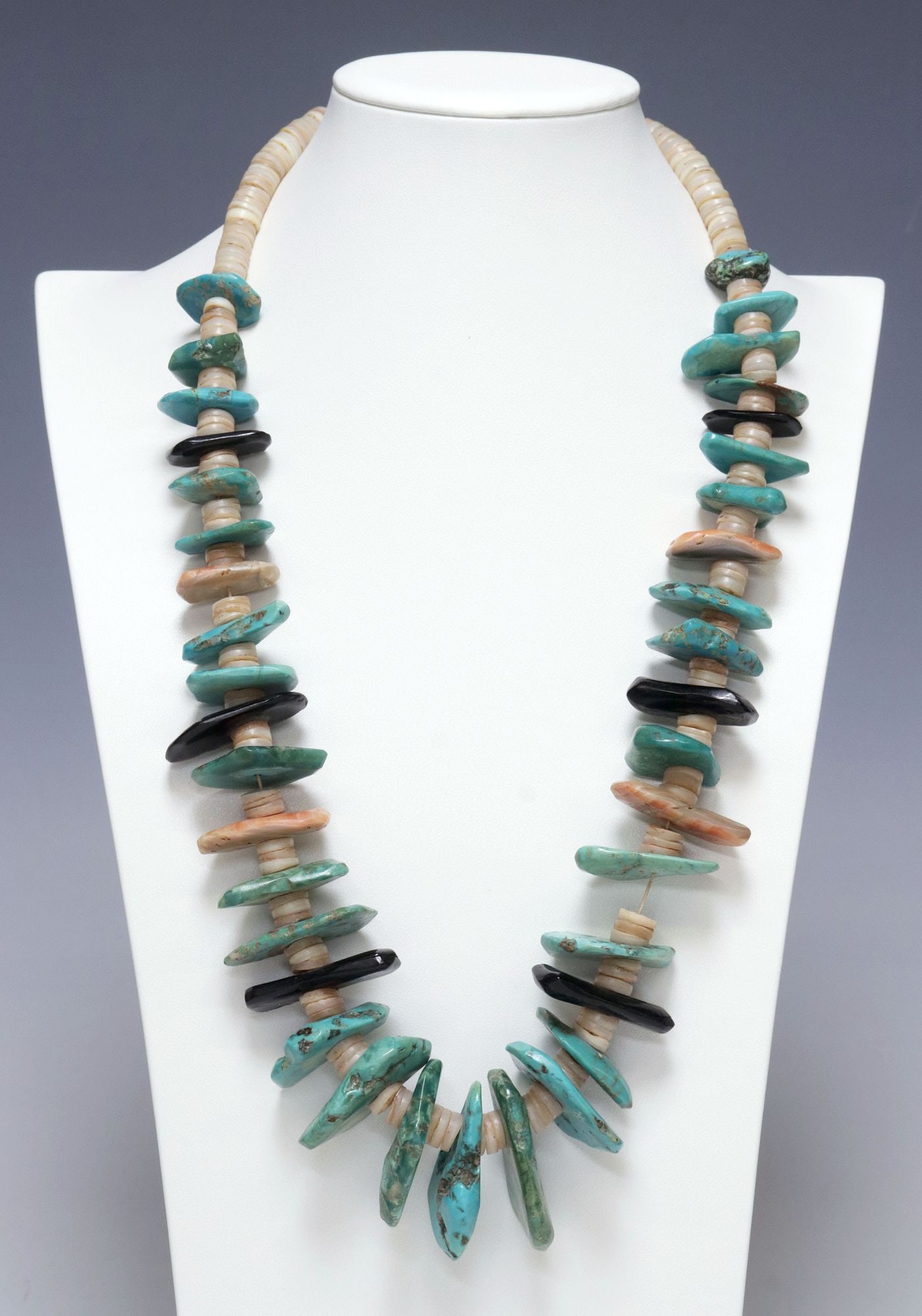 NATIVE AMERICAN CHUNKY TURQUOISE, BLACK STONE & HEISHI SHELL BEADED NECKLACE: Native American beaded necklace, featuring chunky tonal turquoise nuggets, freeform black beads, and abalone, interspersed with heishi disc beads, on tied thread, approx 14.25"l (laying flat), 270.2 g