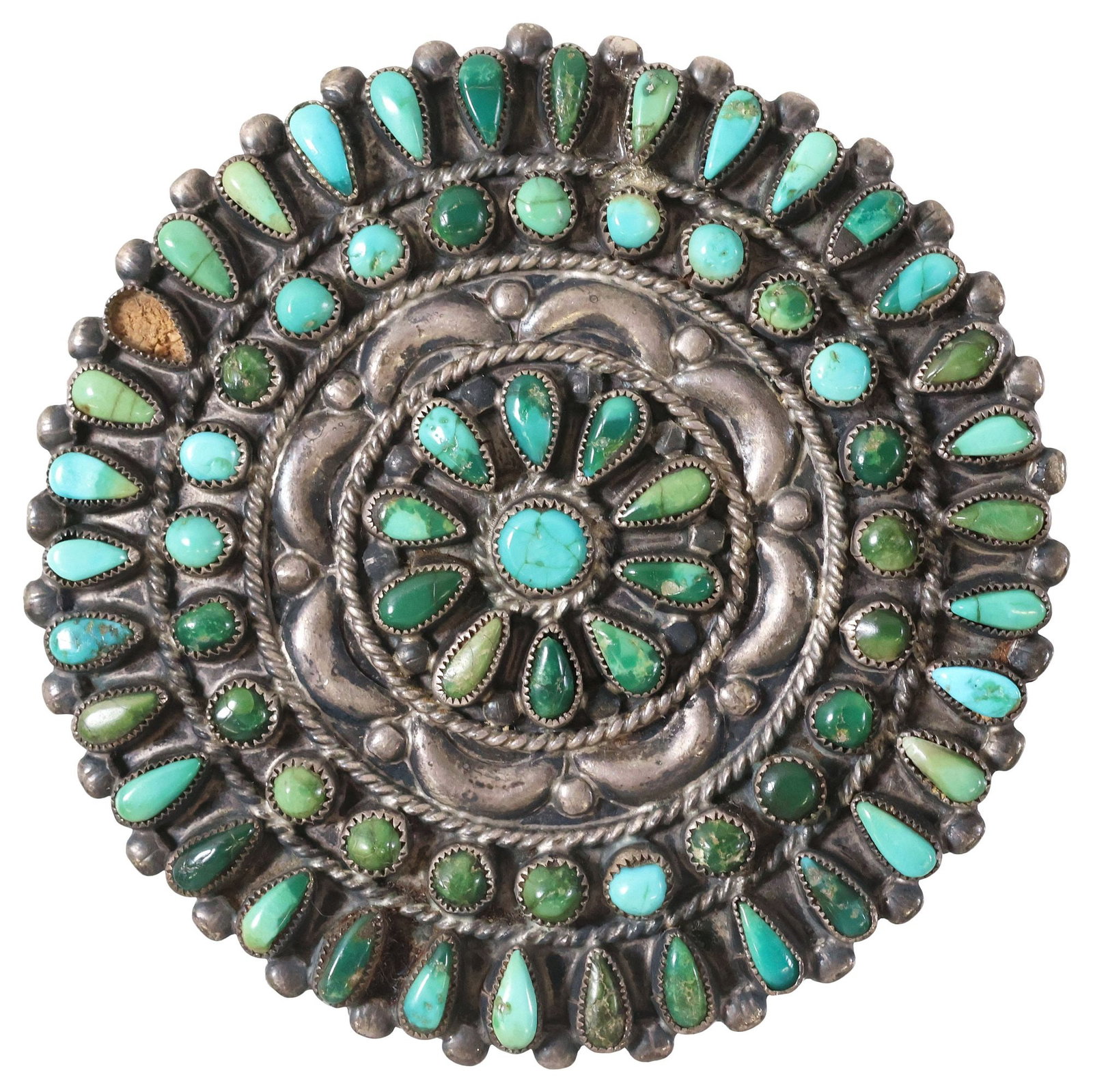 FRANCIS M. BEGAY NAVAJO SILVER & PETIT POINT TURQUOISE CLUSTER BROOCH: Large Native American silver (content unknown) and turquoise brooch, signed FMB (Francis M. Begay, Navajo/ Dine, 20th c.), radiating clusters of petit-point turquoise cabochons, with twisted rope trim