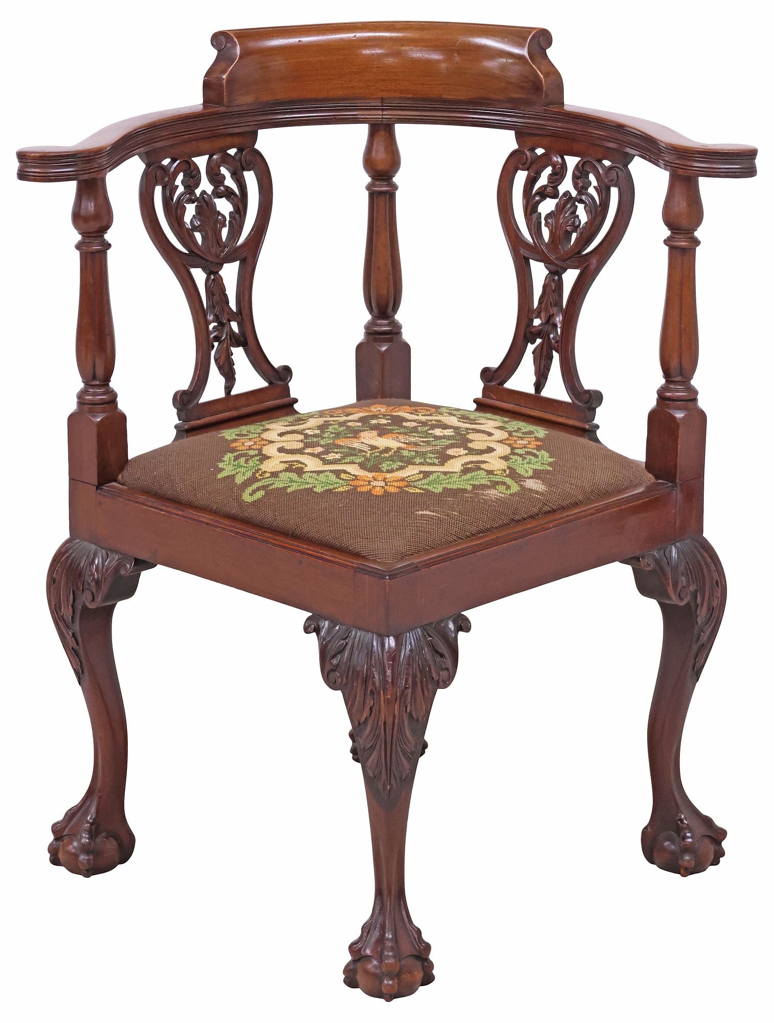 ENGLISH CHIPPENDALE STYLE NEEDLEPOINT & MAHOGANY CORNER CHAIR: English Chippendale style mahogany corner chair, early 20th c., curved back with turned columnar supports and pierced scrollwork splat, square seat in a worn needlepoint upholstery, rising on cabriole