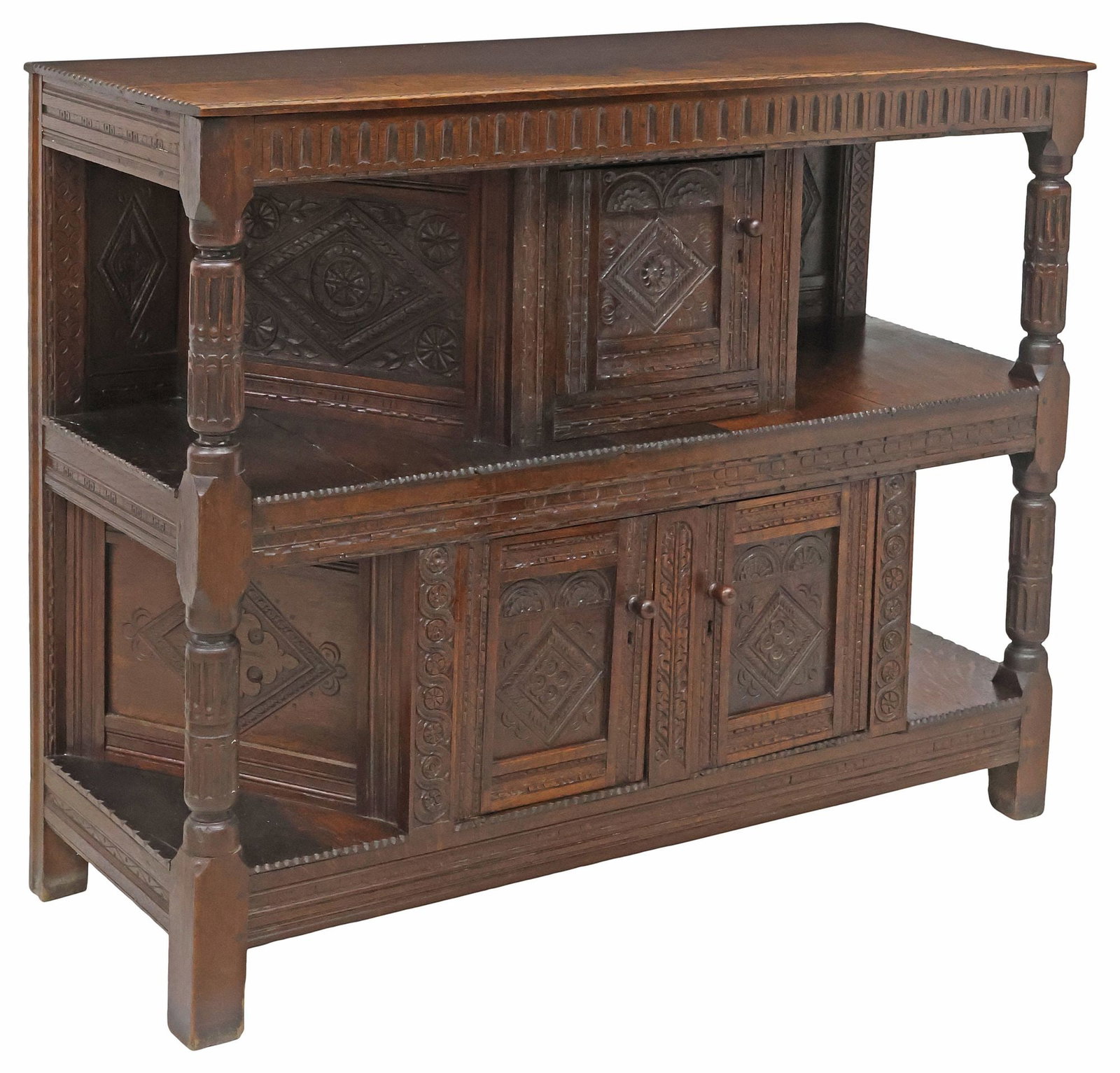 ENGLISH JACOBEAN STYLE HIGHLY CARVED OAK CUPBOARD, 17TH / 18TH C.: English Jacobean style oak buffet/ cupboard cabinet, 17th/ 18th c., rectangular case with notched trim, geometric-carved paneling with fanned medallions and stylized floral motifs, equipped with singl