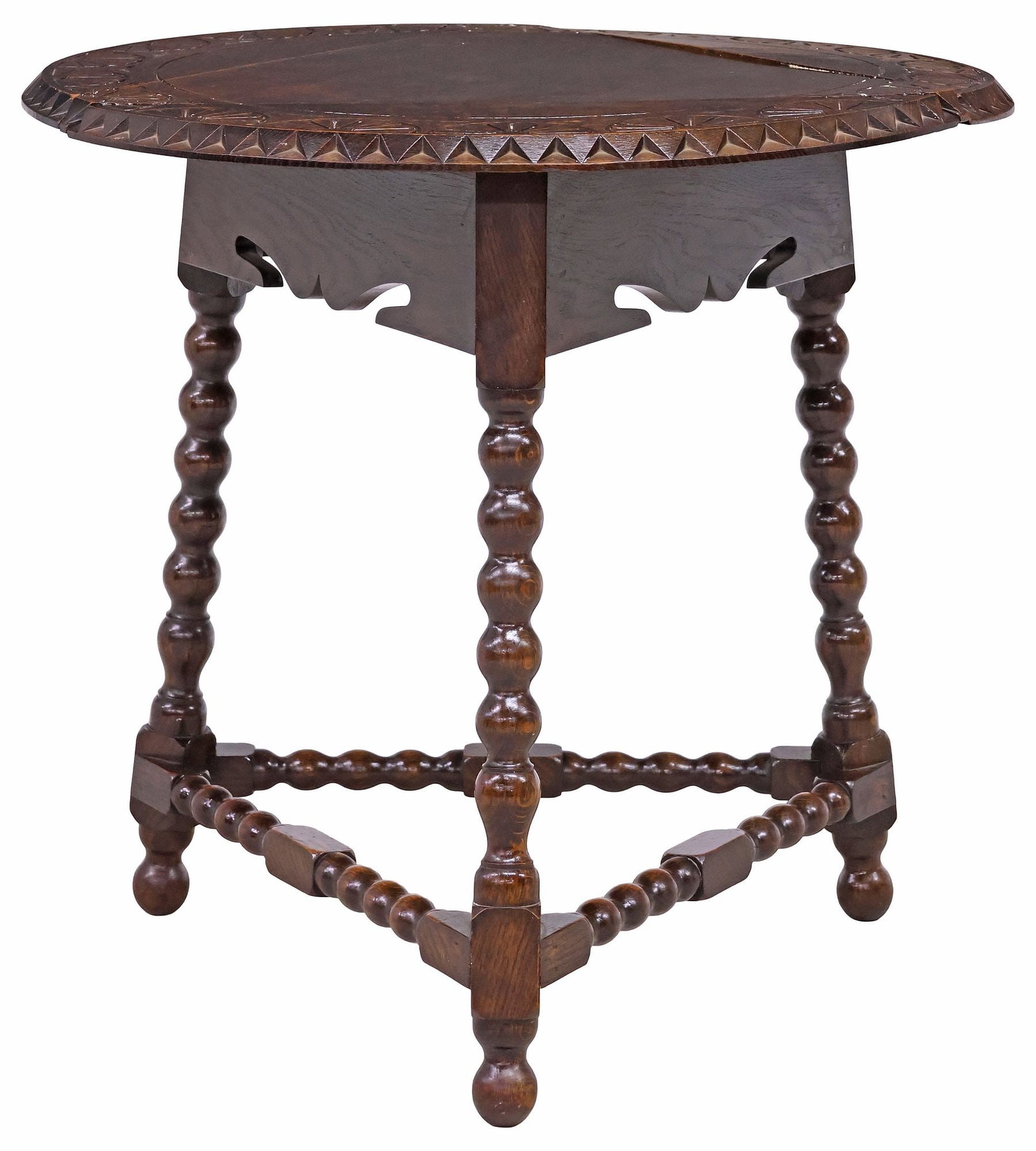 ENGLISH EDWARDIAN CARVED OAK DROP-LEAF SIDE TABLE: English Edwardian oak drop-leaf corner/ side table, early 20th c., having swiveling circular top with carved floral motifs, rising on turned legs joined by matched stretchers, on ball feet, leaves dow