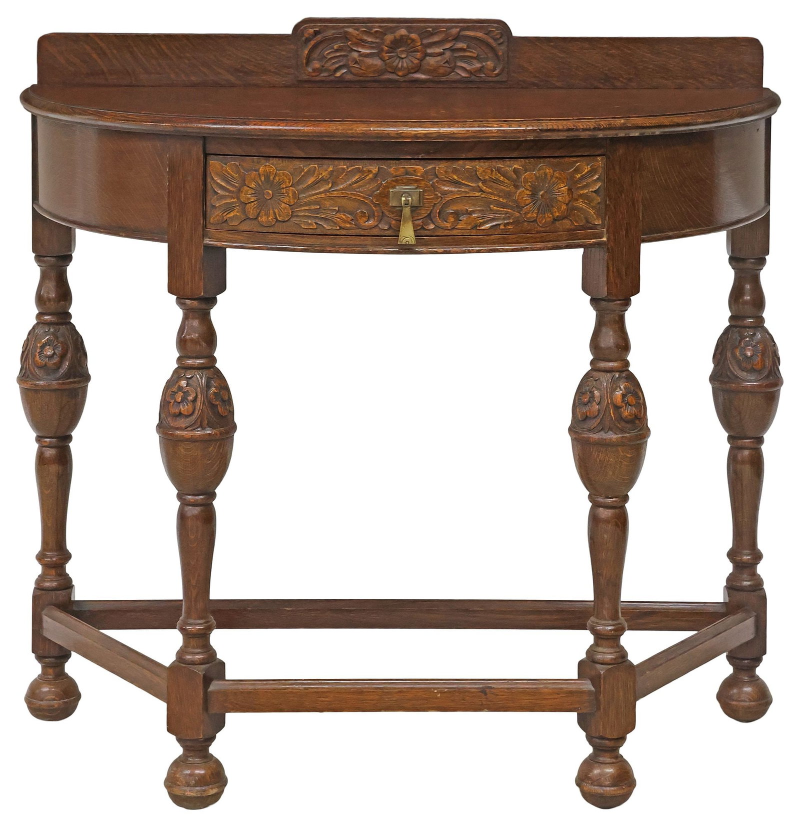 ENGLISH LEEMINGS JACOBEAN REVIVAL CARVED OAK DEMILUNE CONSOLE TABLE: English Jacobean Revival oak console table, Leemings Furnishers Limited, Halifax, early 20th c., having carved crest and demilune top, above single drawer with carved floral motifs, raised on stretche
