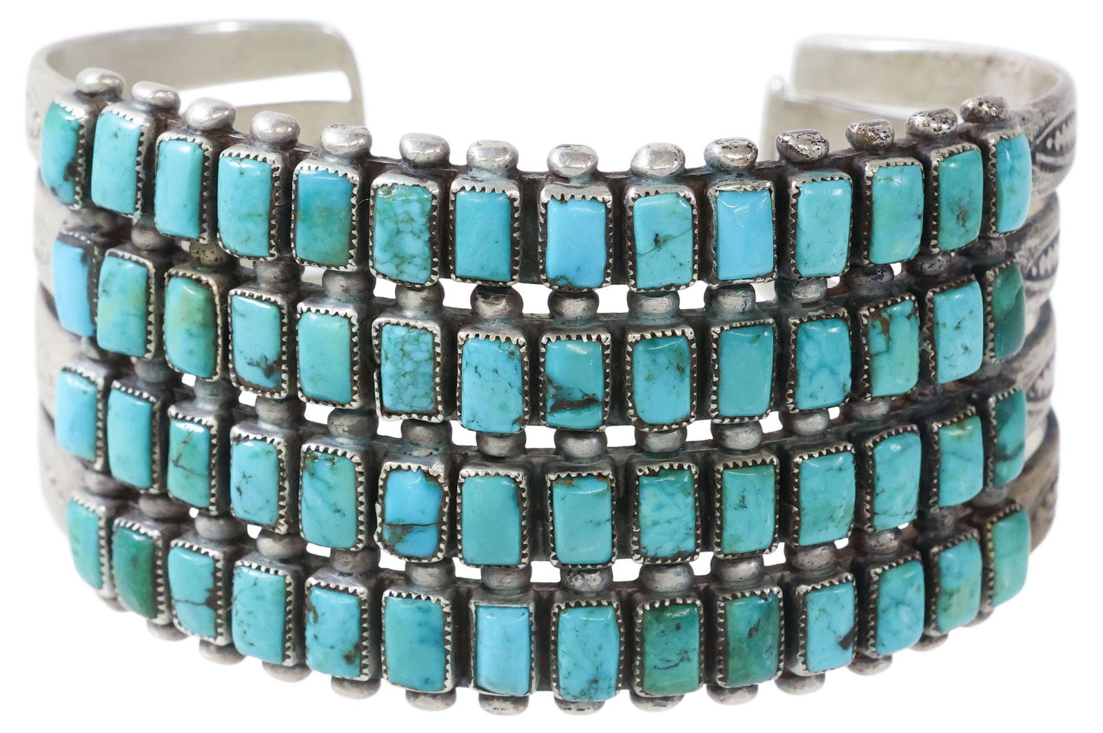 NATIVE AMERICAN SILVER & TURQUOISE WIDE MULTI-LINE CUFF BRACELET: Native American silver (content unknown) cuff bracelet, split shank cuff comprising four rows of (fourteen) rectangular turquoise stones, totaling (fifty-six) cabochons, with spacer beads and stamped 
