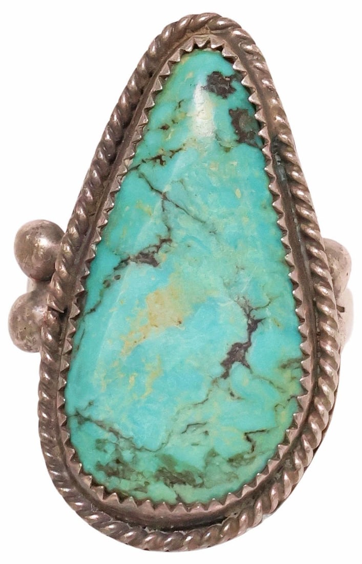 NATIVE AMERICAN SILVER & BEZEL-SET TURQUOISE CABOCHON RING: Native American silver (content unknown) and turquoise ring, large tapering plaque with bezel-set turquoise cabochon, in twisted rope surround, on plain band with beaded terminals, approx size 9.75, 1
