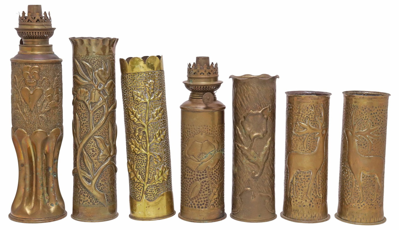 (7) FRENCH WWI-ERA TRENCH ART ARTILLERY SHELL VASES & OIL LAMPS: (lot of 7) French WWI-era trench art table articles, fashioned from artillery shells, including: (2) now fashioned as oil lamps, (pair) with repousse deer motifs, (1) with flowers over textured ground