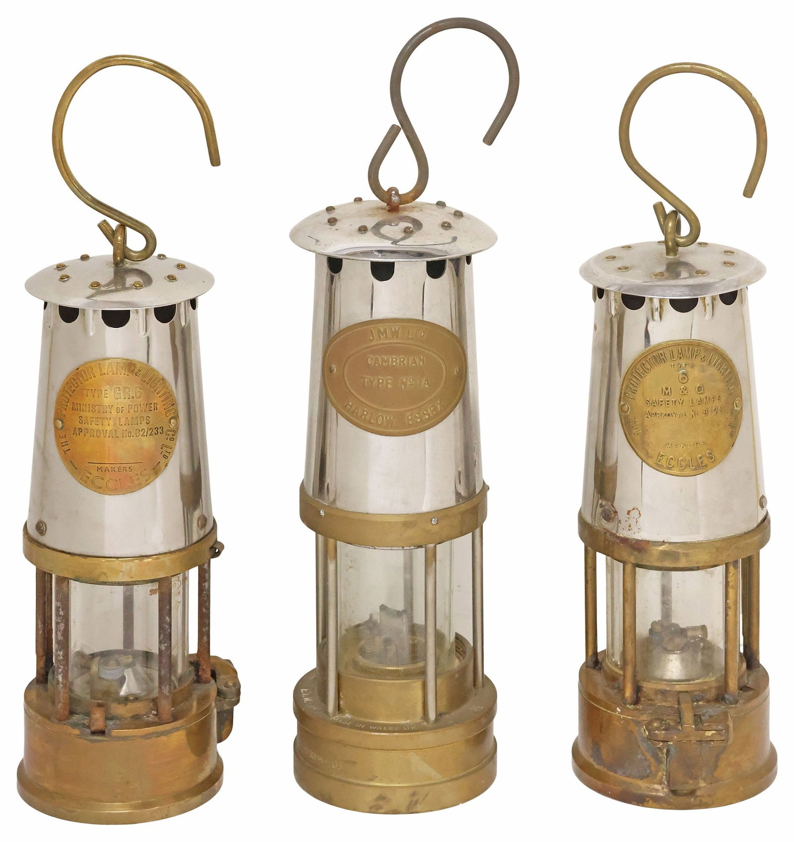 (3) ANTIQUE ENGLISH BRASS MINER'S OIL LAMPS / LANTERNS: (lot of 3) English brass and silver-toned metal miner's oil lamps/ lanterns, early 20th c., each with central maker's plaque, including: (pair) Eccles Protector Lamp and Lighting Company Limited, mode