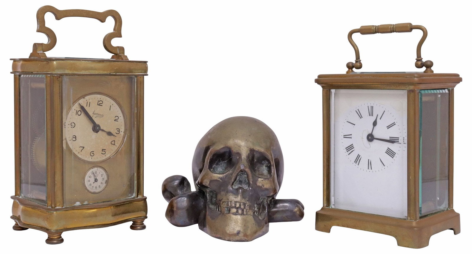 (3) FRENCH BRASS-CASED CARRIAGE CLOCKS & GILT-METAL SKULL ORNAMENT: (lot of 3) Continental gilt-metal clocks and desk ornament, comprising: (2) French glazed brass carriage clocks, each having hinged bail handle, glazed case with inset beveled glass panels, marked Fra