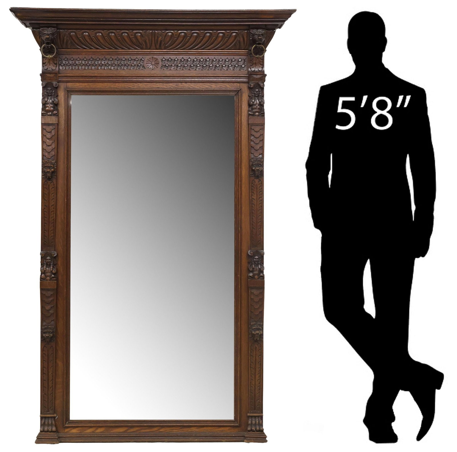 ENGLISH VICTORIAN CARVED OAK BEVELED TRUMEAU MIRROR: English Victorian carved oak pier mirror, late 19th c., having molded cornice, and lobed frieze flanked by beast masks with captured brass ring, encasing beveled mirror plate, framed by foliated posts