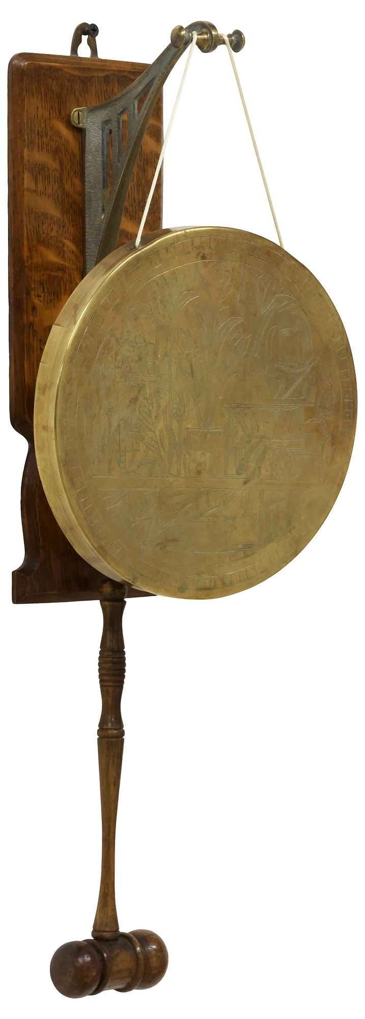 ENGLISH EDWARDIAN OAK & BRASS WALL-HANGING DINNER GONG: English Edwardian oak and brass wall-hanging dinner gong, early 20th c., shaped wall plaque issuing brass scrolled hooks, suspending gong plate with incised Egyptian-style scene, marked on back XM PT 
