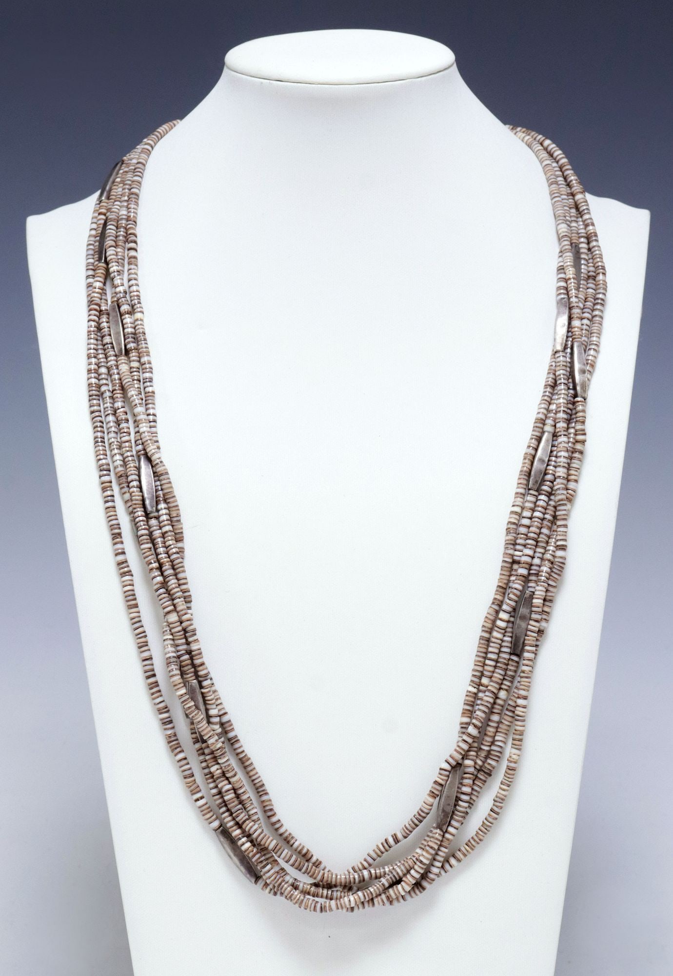 NATIVE AMERICAN HEISHI SHELL & SILVER BEADED 6-STRAND NECKLACE: Native American multi-strand beaded necklace, six strands of shell heishi beads, interspersed with elongated silver (content unknown) metal barrel beads, hook clasp, approx 26"l, 76 grams **Provenance