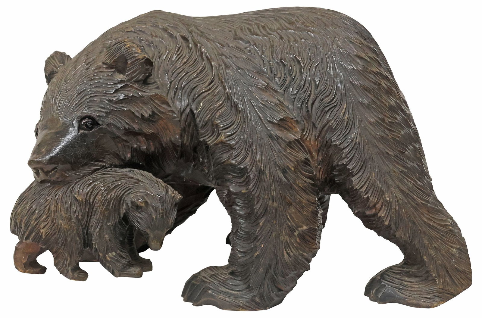 JAPANESE HOKKAIDO AINU STYLE CARVED WOOD BEAR & CUB SCULPTURE: Japanese Ainu style carved wood bear sculpture, likely Hokkaido, modeled as a standing bear with a cub in its mouth, with inset glass eyes, approx 9.5"h, 14.5"w, 5"d, 6lbs